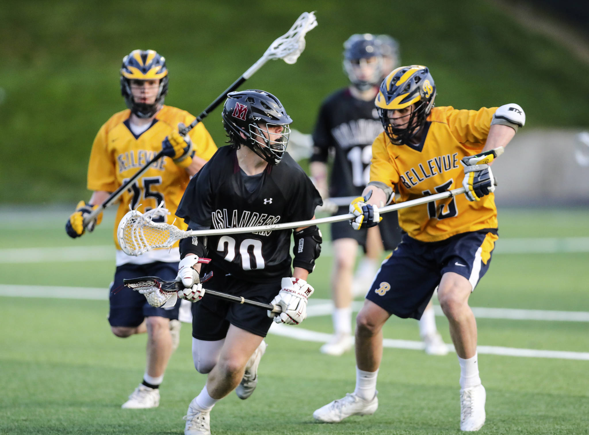 Photo courtesy of Rick Edelman/Rick Edelman Photography                                The Bellevue Wolverines boys lacrosse team earned a 8-6 victory against the Mercer Island Islanders in the Washington High School Boys Lacrosse Association 3A state title game on May 26 at the Starfire Sports Complex in Tukwila. Bellevue finished the 2018 season with an overall record of 17-2. The Islanders finished with an overall record of 16-7. Mercer Island player junior Donnie Howard, left, tries to maneuver around Bellevue player in the title contest.