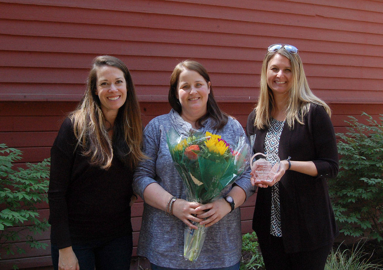MIPA Co-VPs of Preschool Jessica Apodaca and Amanda Colburn present Michele Saunders with the Exceptional Educator award. Katie Metzger/staff photo