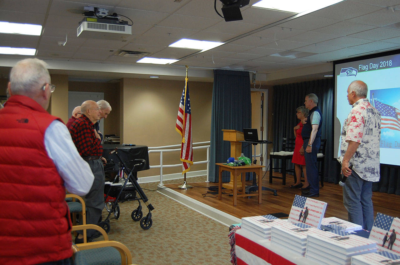 Attendees say the Pledge of Allegiance at the Flag Day ceremony at Covenant Shores on June 14. Katie Metzger/staff photo