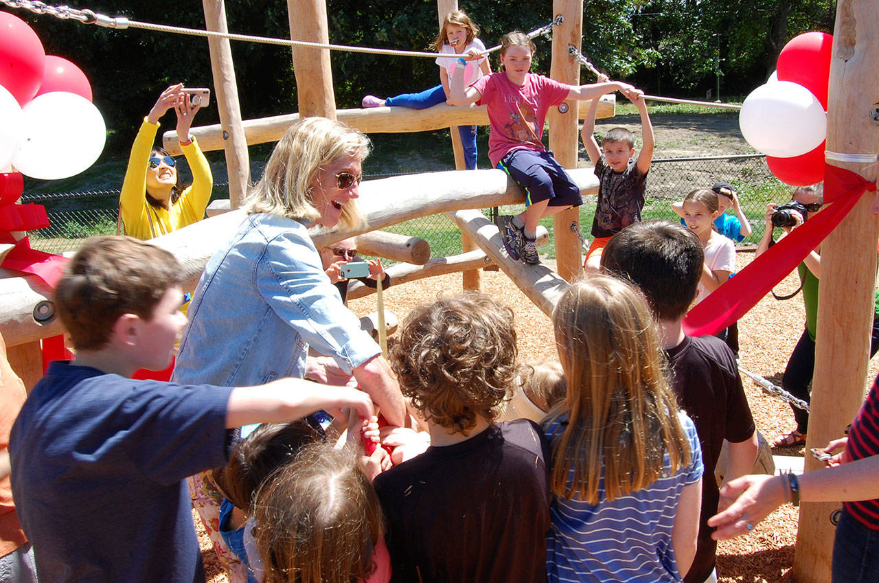 Mayor Debbie Bertlin and local kids help cut the ribbon at the South Mercer Playfield’s new playground. Katie Metzger/staff photo