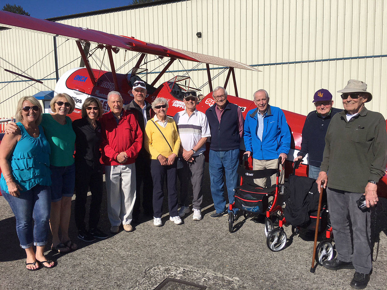 From right, Covenant Shores staff Roxanne Helleren and Leslie McGee pose with sponsor Sports Clip’s Andrea Wick, resident Bob Weber, pilot Mike Sommars and residents Bette Bjornestad, Ron Ross, Charlie Hammer, Owen Hall, Zip Zuther and Joe Morton.