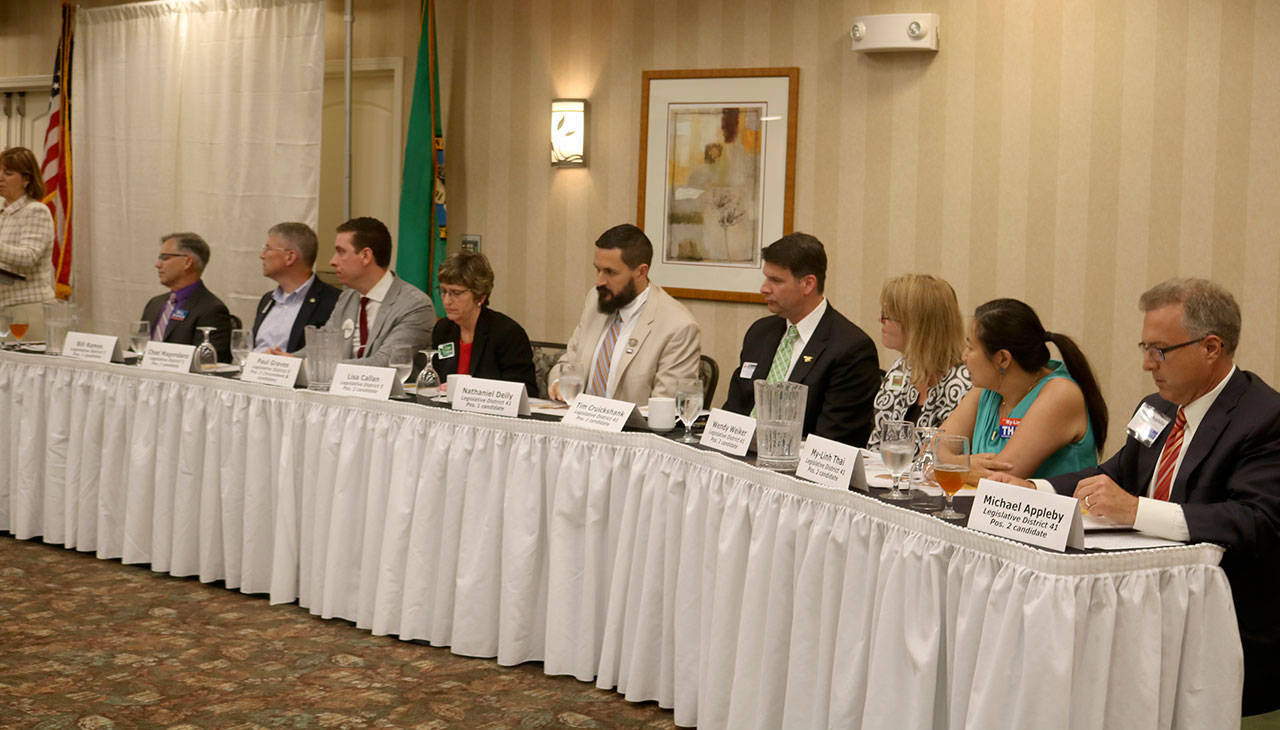 The legislative candidates sat at the table to the right of the moderator at the forum. From left: Bill Ramos, Chad Magendanz, Paul Graves, Lisa Cullen, Nathaniel Deily, Tim Cruickshank, Wendy Weiker, My-Linh Thai, and Michael Appleby. Evan Pappas/Staff Photo