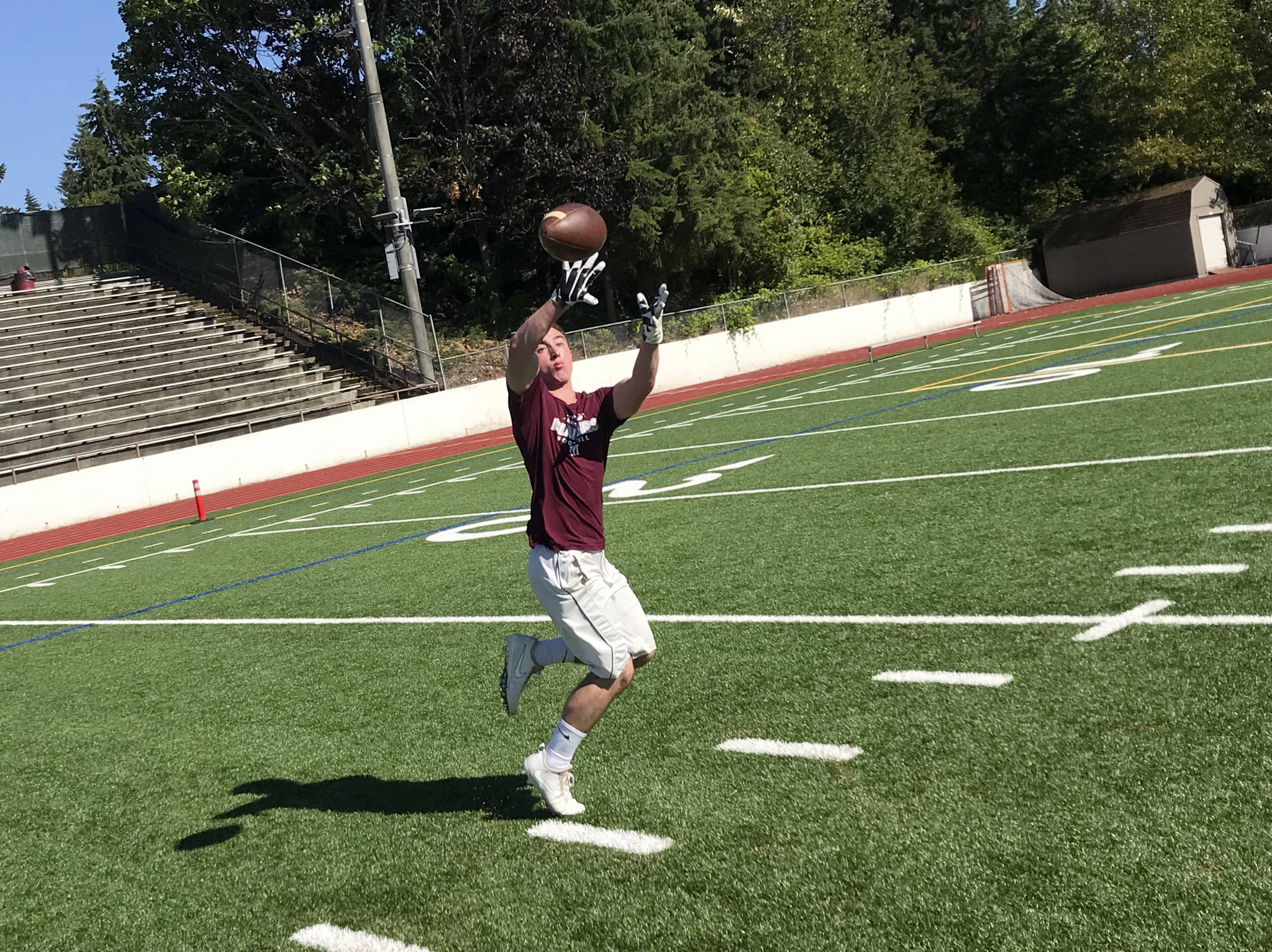Mercer Island senior football player John Majewski hauls in a pass during a player led team workout on July 18 on Mercer Island. The Islanders, who finished with an overall record of 7-4 during the 2018 season, are looking to build on last year’s sensational season on the gridiron.                                Shaun Scott, staff photo