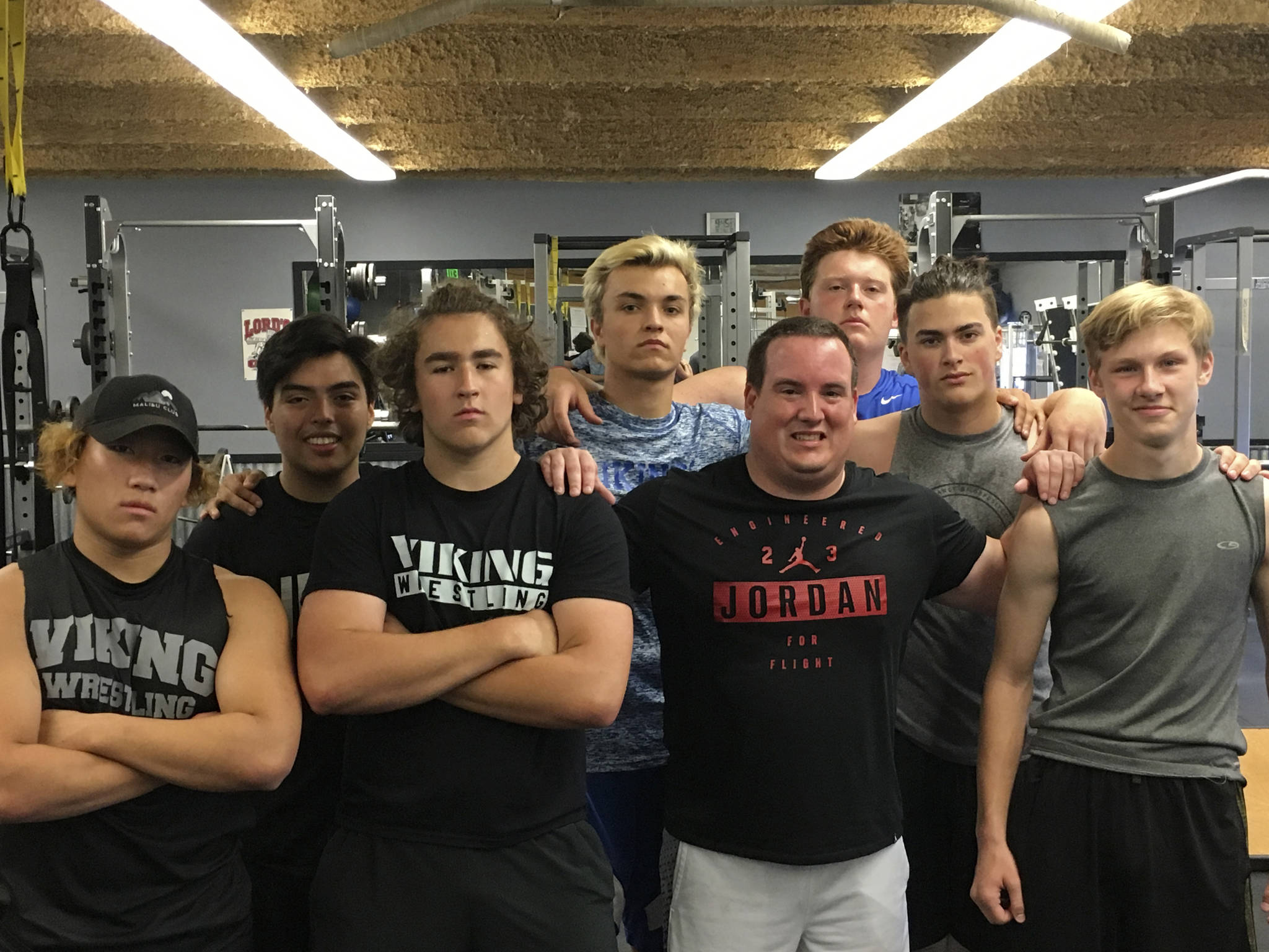 Sound Publishing sportswriter Shaun Scott poses for a quick picture with members of the Bellevue Christian Vikings football team following a weight training session on July 19 at Bellevue Christian School in Bellevue.                                Photo courtesy of Todd Green
