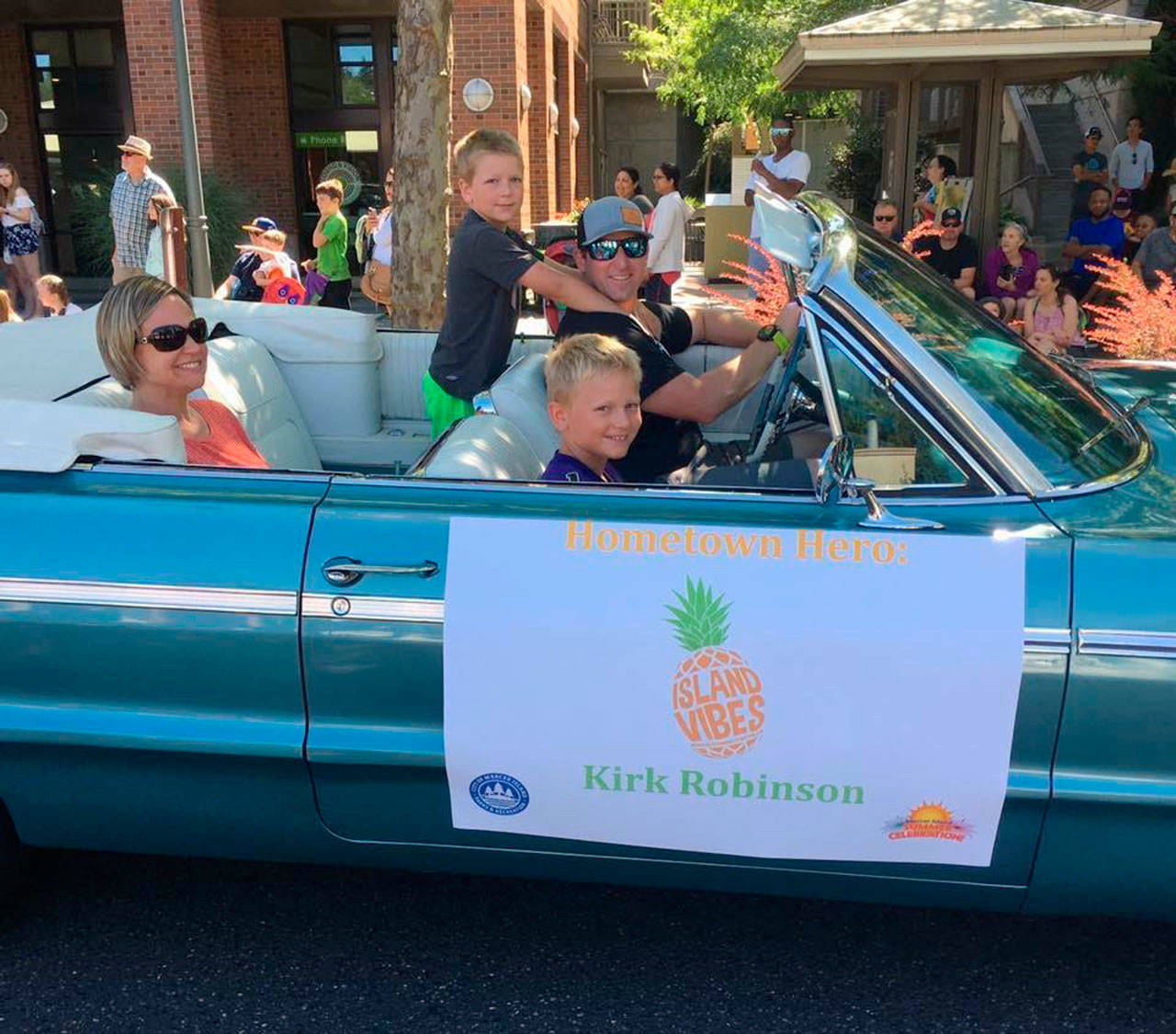 Kirk Robinson rides in the Mercer Island Summer Celebration parade with his family. Robinson is a firefighter and community volunteer who was recently diagnosed with cancer. Photo courtesy of Kirk Robinson