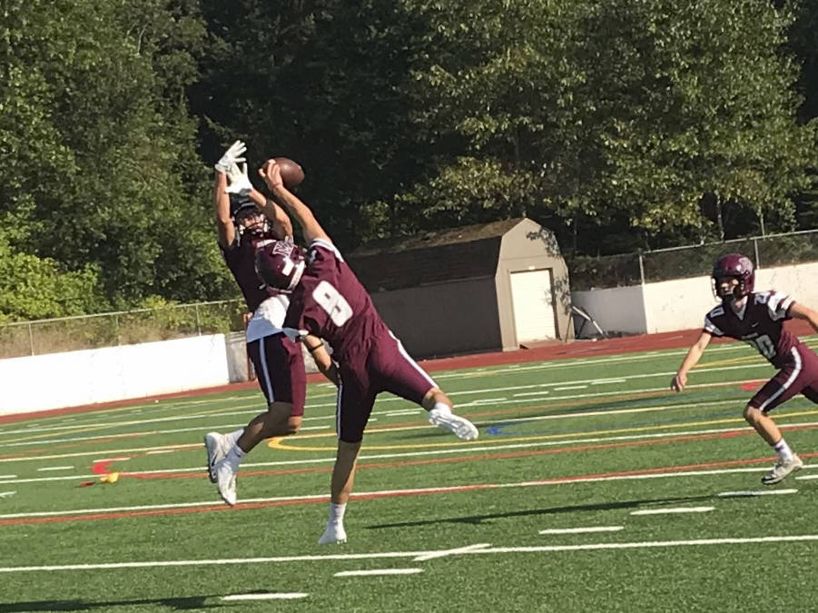 Mercer Island Islanders defensive back/wide receiver Henry Weiker (No. 8) makes a play on the ball during position drills on Aug. 17 on Mercer Island. Shaun Scott/staff photo