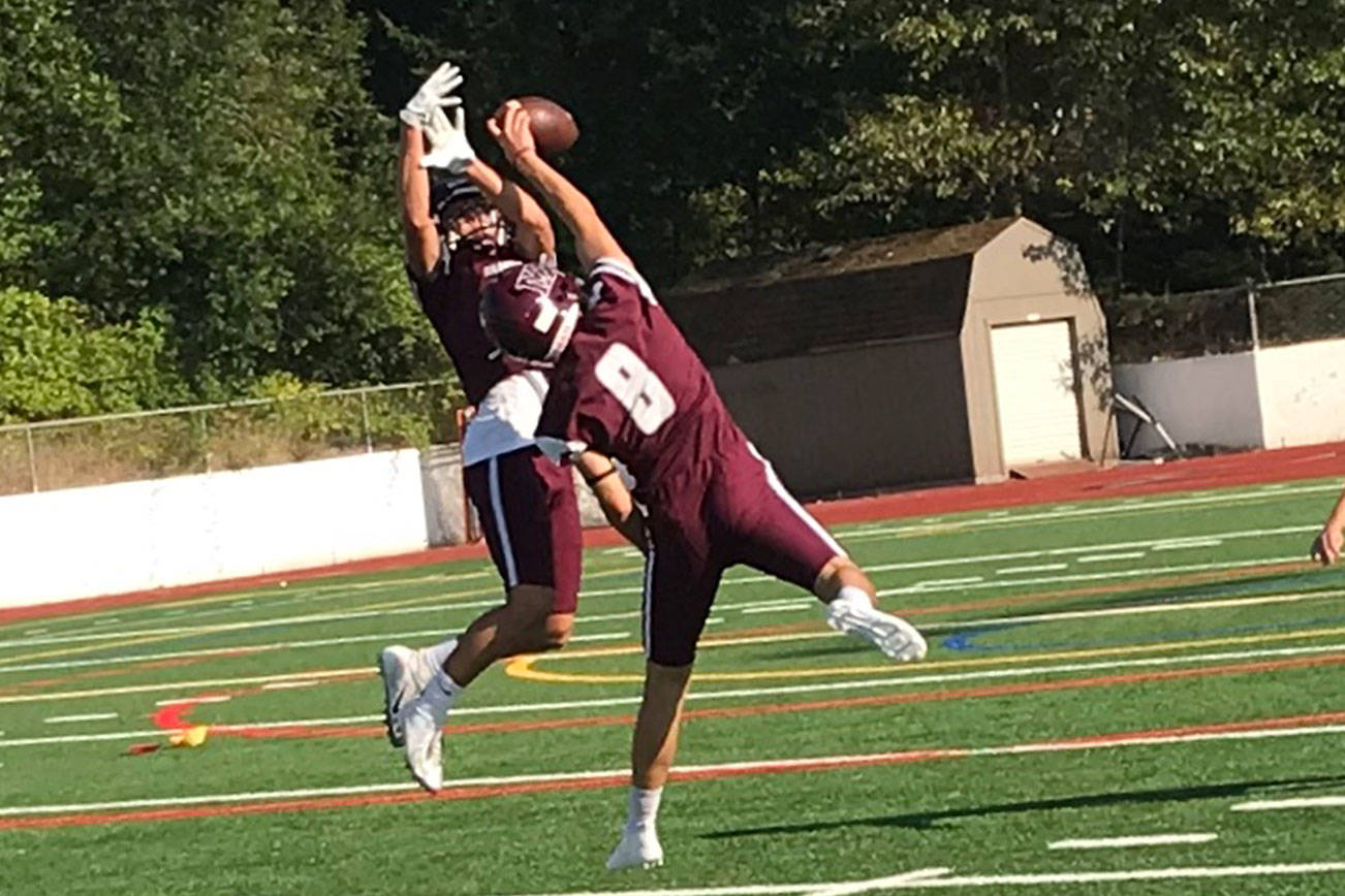 Mercer Island Islanders defensive back/wide receiver Henry Weiker (No. 8) makes a play on the ball during position drills on Aug. 17 on Mercer Island. Shaun Scott/staff photo