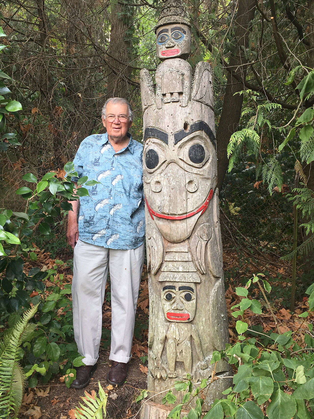 Bob Wiley stands next to a totem pole he carved in 1992 and recently donated to Covenant Shores on Mercer Island. Photo courtesy of Greg Asimakoupoulos