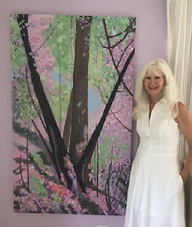 Mercer Island artist Pat Howie poses with her work. Photo courtesy of MIVAL