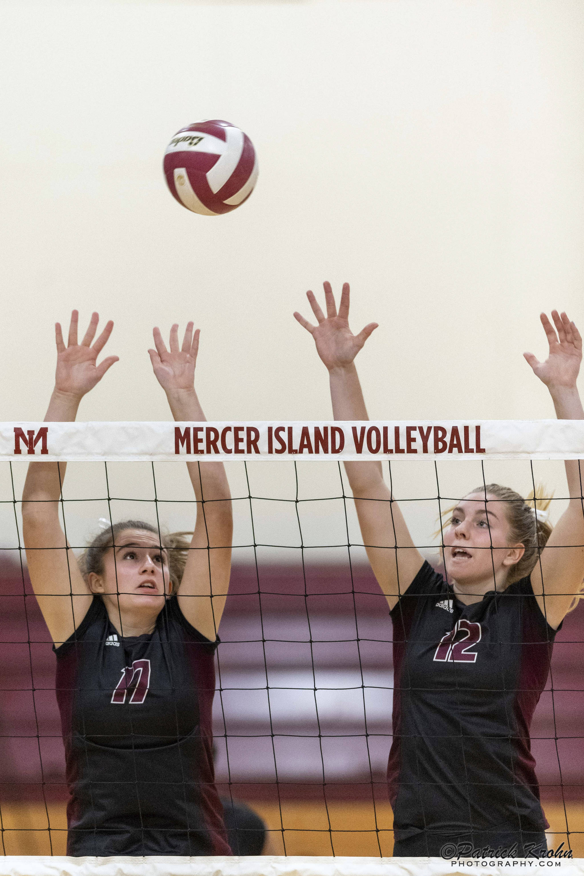 Mercer Island volleyball players Anika Iverson, left, and Quinn Casey, right, leap into the air against the Skyline Spartans in a non-league contest on Sept. 12 on Mercer Island. Skyline defeated Mercer Island 3-1 in the matchup. Photo courtesy of Patrick Krohn/Patrick Krohn Photography