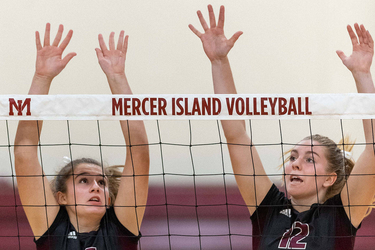 Mercer Island volleyball players Anika Iverson, left, and Quinn Casey, right, leap into the air against the Skyline Spartans in a non-league contest on Sept. 12 on Mercer Island. Skyline defeated Mercer Island 3-1 in the matchup. Photo courtesy of Patrick Krohn/Patrick Krohn Photography