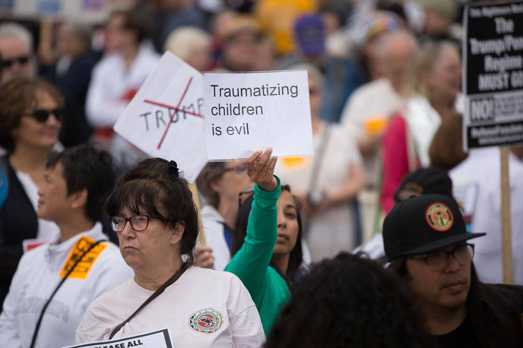 Protesters gather at SeaTac’s Families Belong Together rally. Photo by Alex Garland