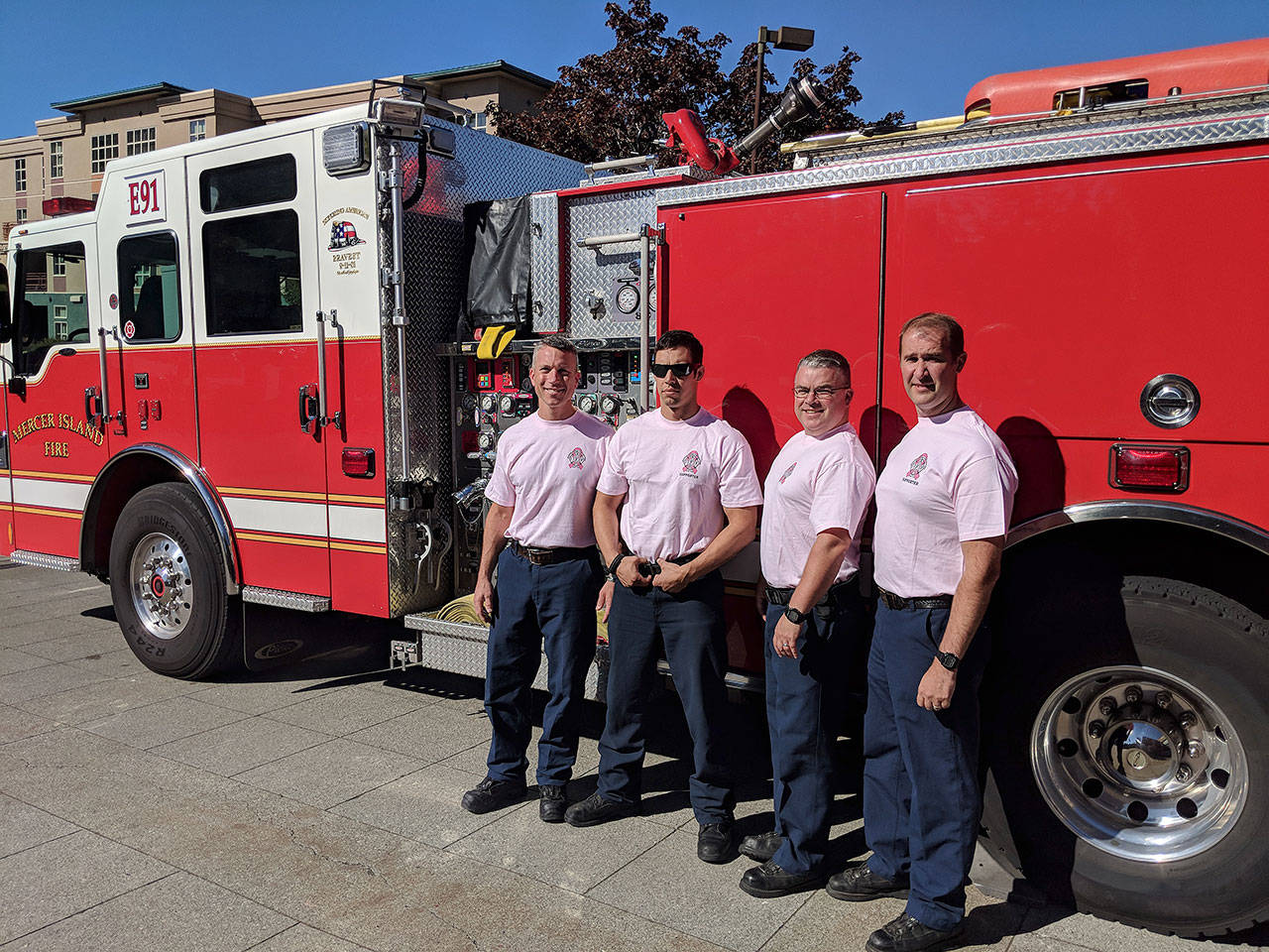 (From left) Mercer Island firefighters Lt. Ray Austin, Dan Jackson, Alec Munro and Lt. Steve McCoy pose for a picture in their pastel pink breast cancer awareness shirts. Photo courtesy of Ray Austin