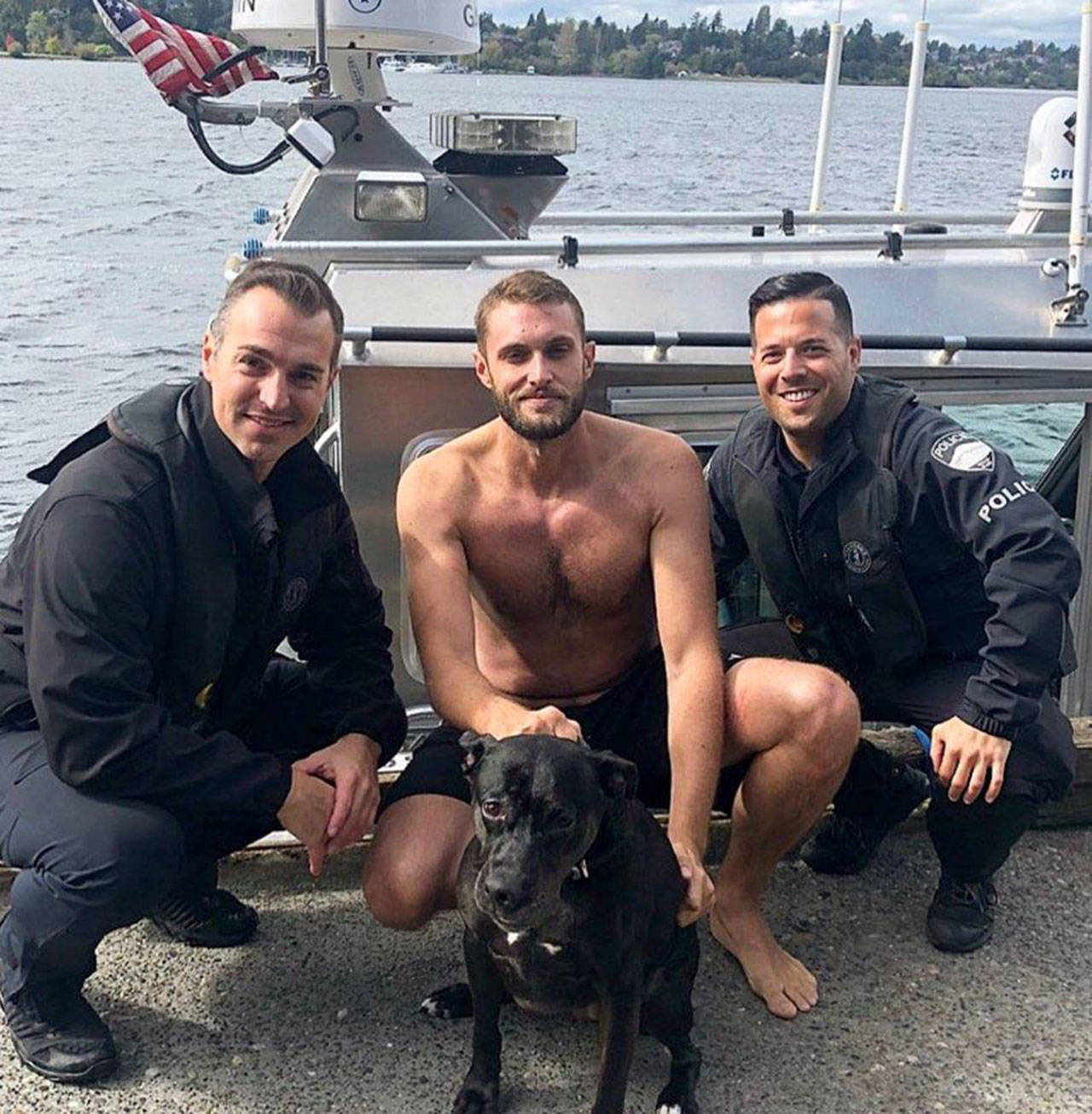 Detective Bobby Jira (left) and Cpl. David Canter (Right) pose with Nate Palmer and Juno (Center) after a successful rescue. Photo courtesy of the Mercer Island Police and Emergency Management Facebook page