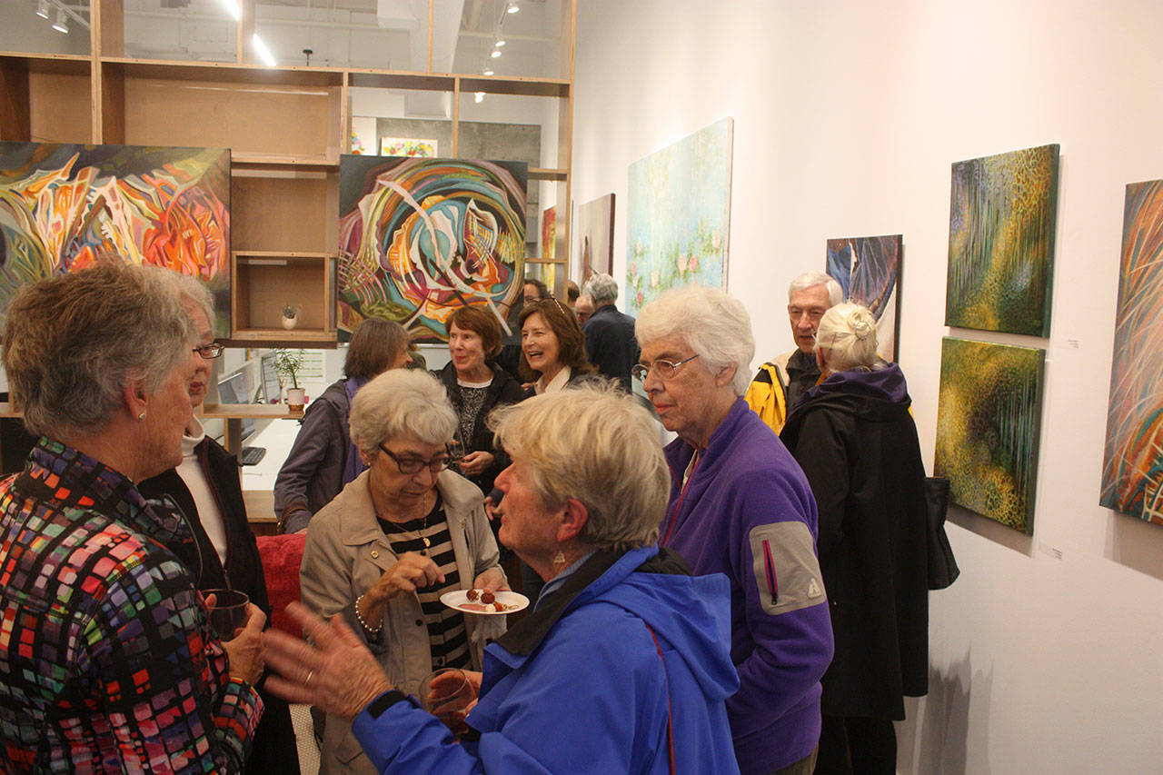 Islanders gather for a reception to view Lucia Neagu’s art at Suzanne Zahr’s SZ Gallery for October’s First Friday art and wine event. Katie Metzger/staff photo