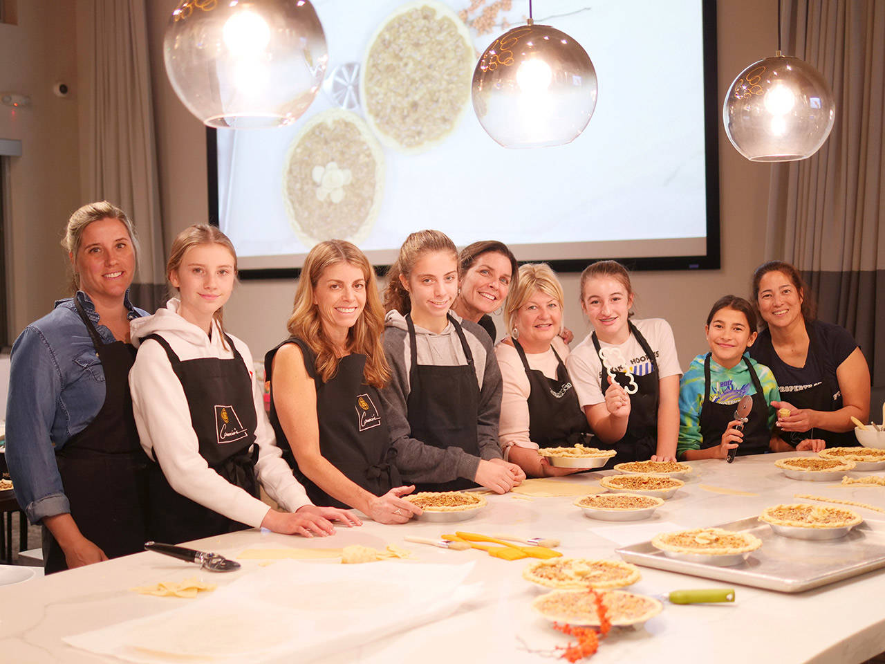 Mothers and daughters from the Lake Washington National Charity League helped prepare Thanksgiving dinners at Caruccio’s on Mercer Island. The meals were donated to Youth and Family Services. Photo courtesy of Cindy Swain