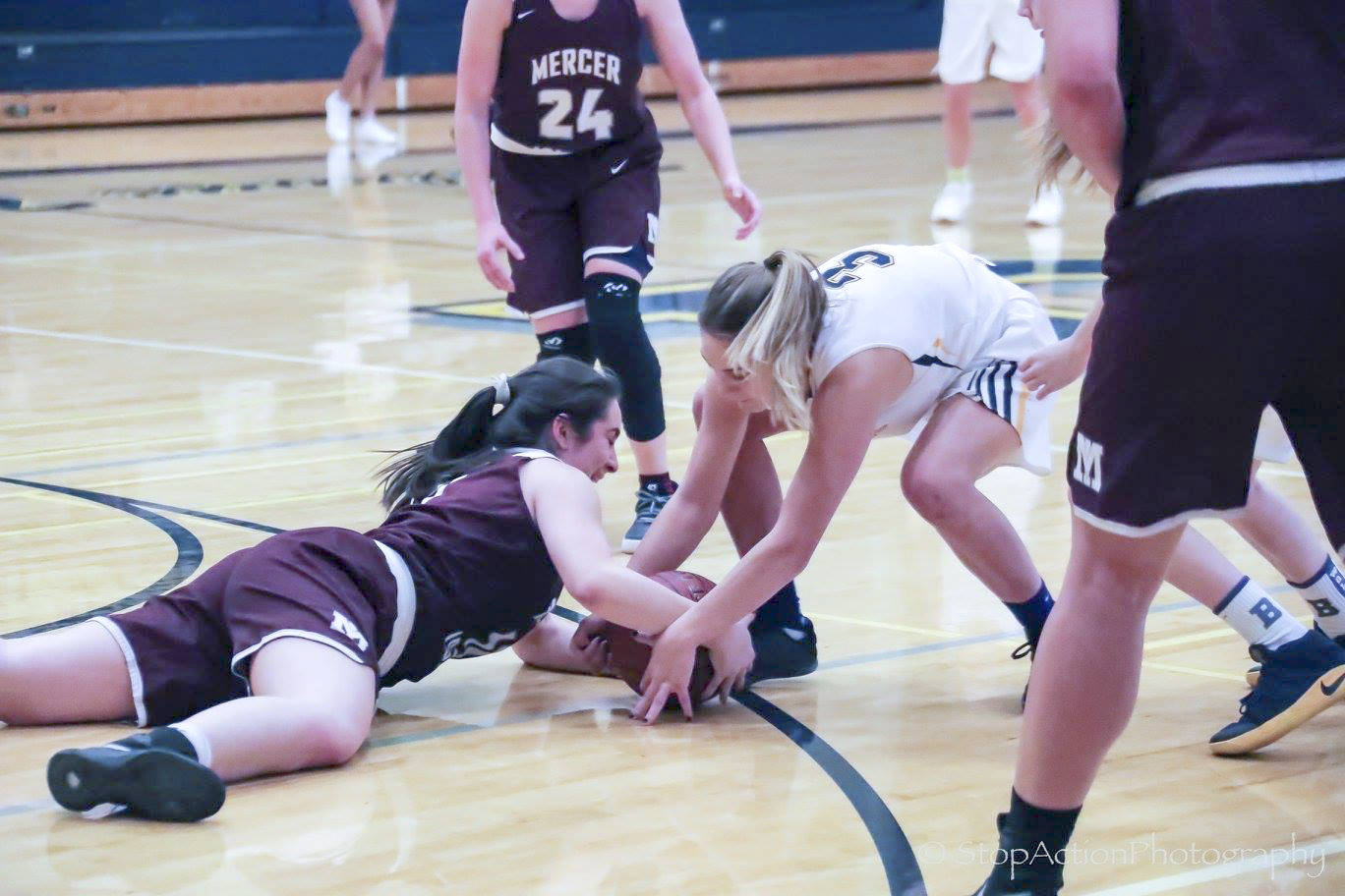 Mercer Island Islanders senior girls basketball player Angelina Barokas (pictured) dove for a loose ball against Bellevue in a game during the 2017-18 season. Barokas, who was a member of the Class 3A state championship squad two years ago as a sophomore, is determined to lead her team back to the Class 3A state tournament this March. Photo courtesy of Don Borin/Stop Action Photography