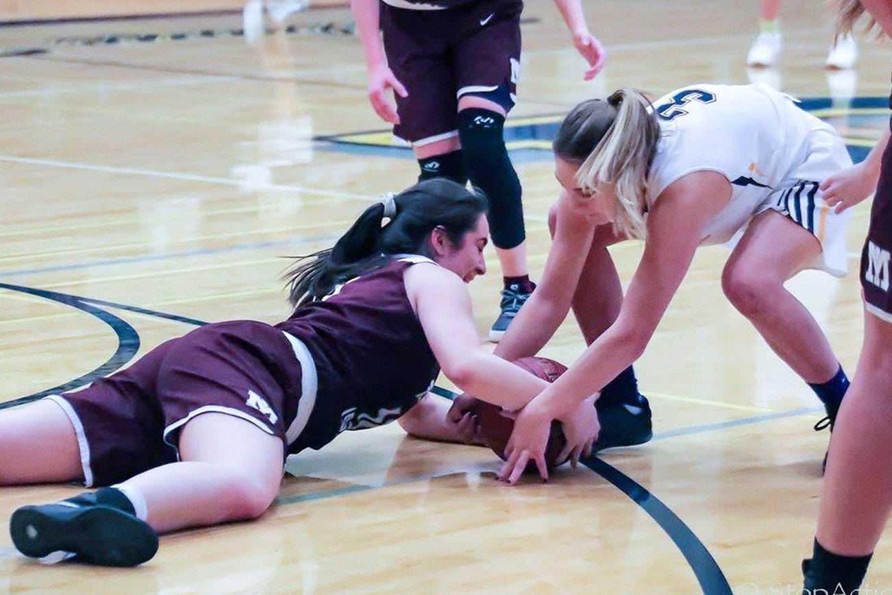 Mercer Island Islanders senior girls basketball player Angelina Barokas (pictured) dove for a loose ball against Bellevue in a game during the 2017-18 season. Barokas, who was a member of the Class 3A state championship squad two years ago as a sophomore, is determined to lead her team back to the Class 3A state tournament this March. Photo courtesy of Don Borin/Stop Action Photography