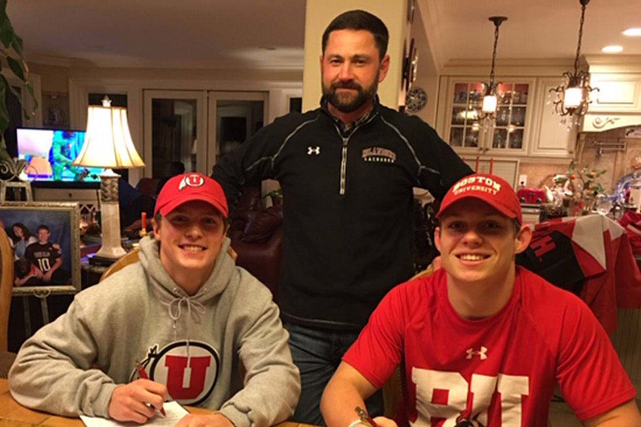 Mercer Island Islanders seniors Stew Vassau, left, and Donnie Howard, right, signed their letters of committment on Nov. 19 to continue their lacrosse careers at the collegiate level. Vassau will play lacrosse for the University of Utah and Howard will continue his lacrosse career at Boston University. Mercer Island boys lacrosse head coach Ian O’Hearn, center, is pictured with his two collegiate bound players. Photo courtesy of Don Howard