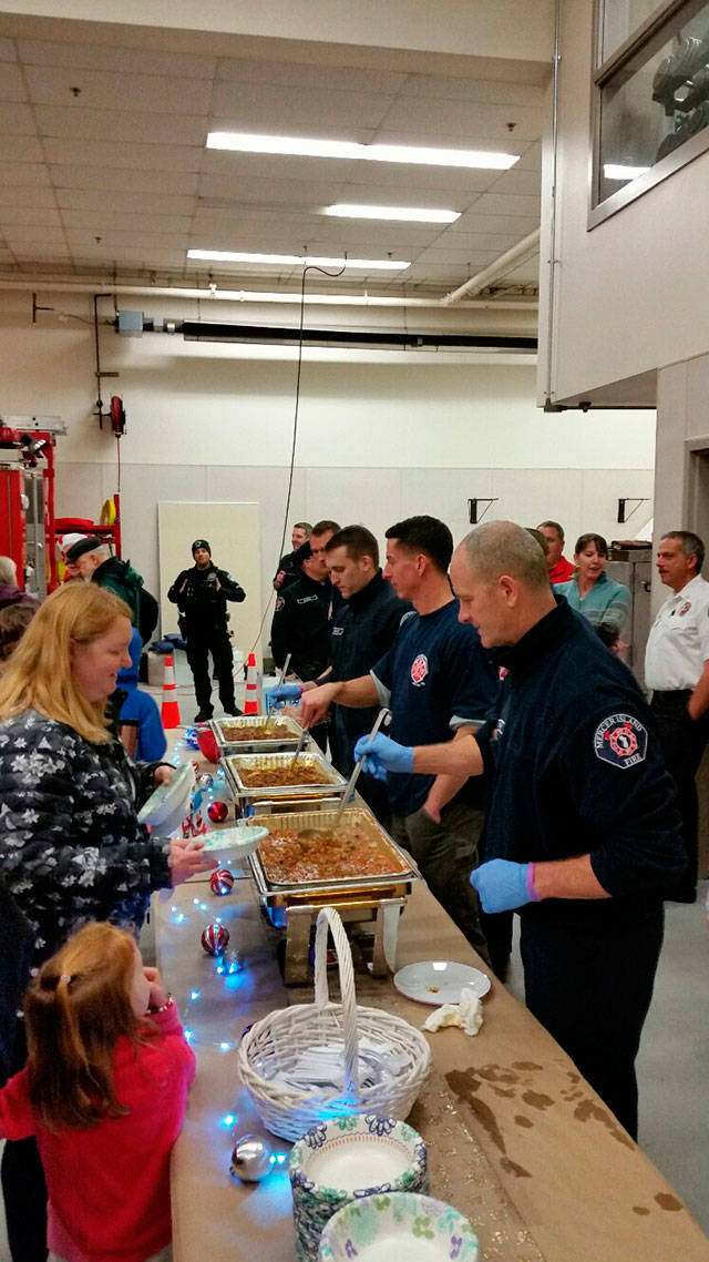 (Closest to farthest) Mercer Island Firefighters Curt Groscost, Shane Gruger, Joe White, Andrew Pearson serve homemade chili to locals attending the 2017 Firehouse Munch. Photo courtesy of the city of Mercer Island