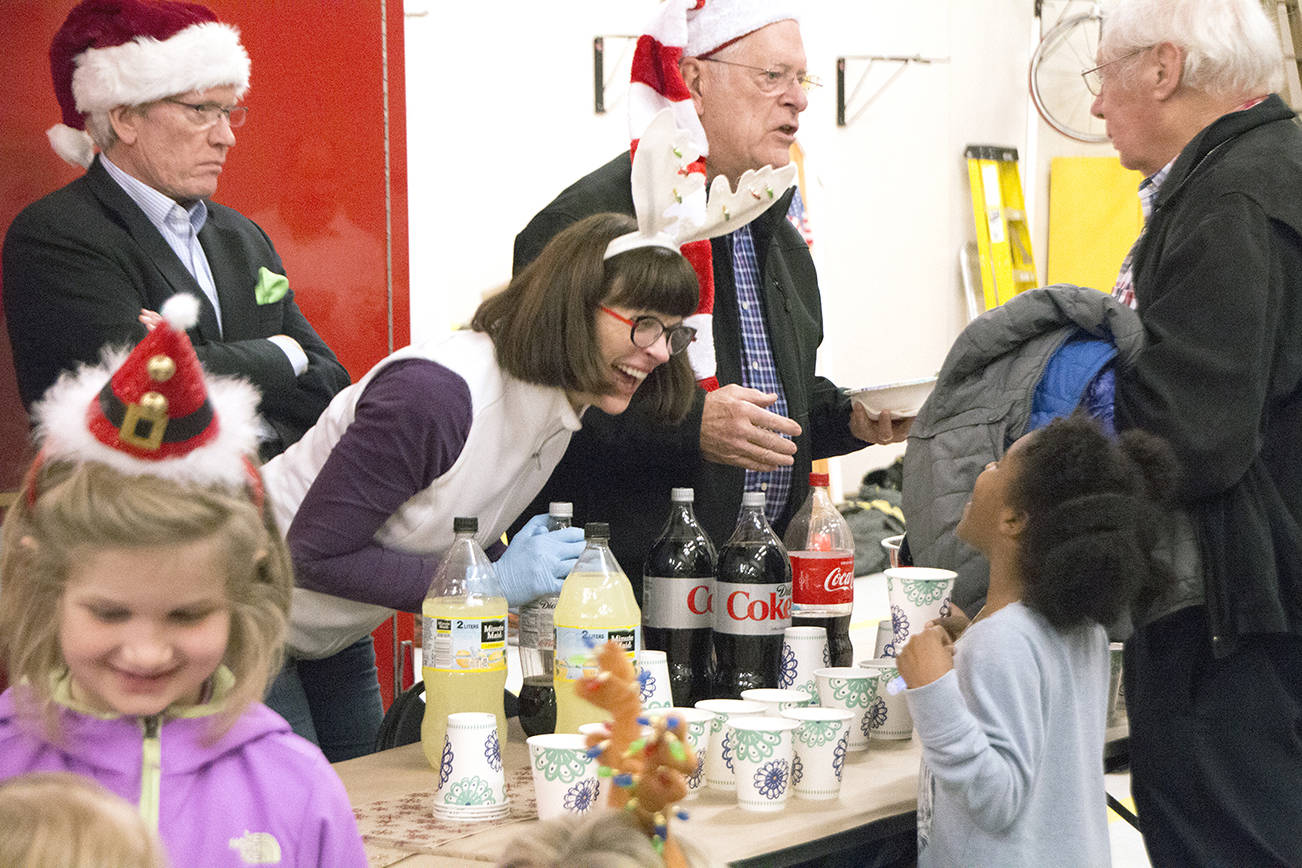 A volunteer shares a laugh with a girl during the city of Mercer Island’s Firehouse Munch event at the North Fire Station in 2017. Photo courtesy of Robert Stoneburner