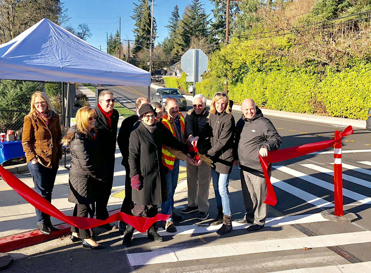 Mercer Island City Councilmember Wendy Weiker, Mercer Island School District Superintendent Donna Colosky, School Board members Brian Giannini Upton and Tracy Drinkwater, Mayor Debbie Bertlin and others help cut the ribbon for a new Safe Route to School project near Northwood Elementary. Photo via Facebook