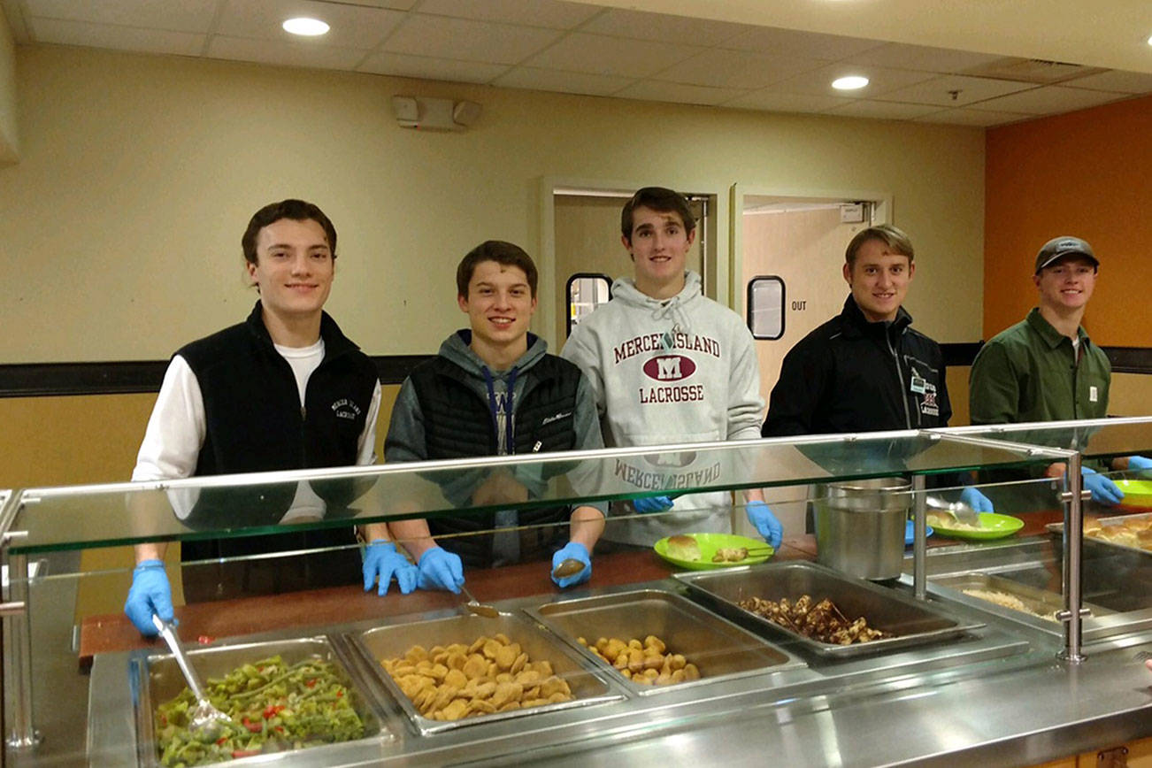 Members of the Mercer Island Lacrosse Club spent the evening of Dec. 12 volunteering at the Union Gospel Mission’s Hope Place in Seattle. The players prepared and served dinner to more than 100 guests who enjoyed a meal of chicken satay, rice, peanut sauce, mixed vegetables, fruit skewers and a brownie sundae bar. The Union Gospel Mission’s Hope Place is a shelter that serves women and children. Mercer Island boys lacrosse players Peter Davis, Paul Murdoch, Hunter Johnson, Rurger Marks and Stu Vassau are pictured in the above photo. Photo courtesy of Maryellen Johnson