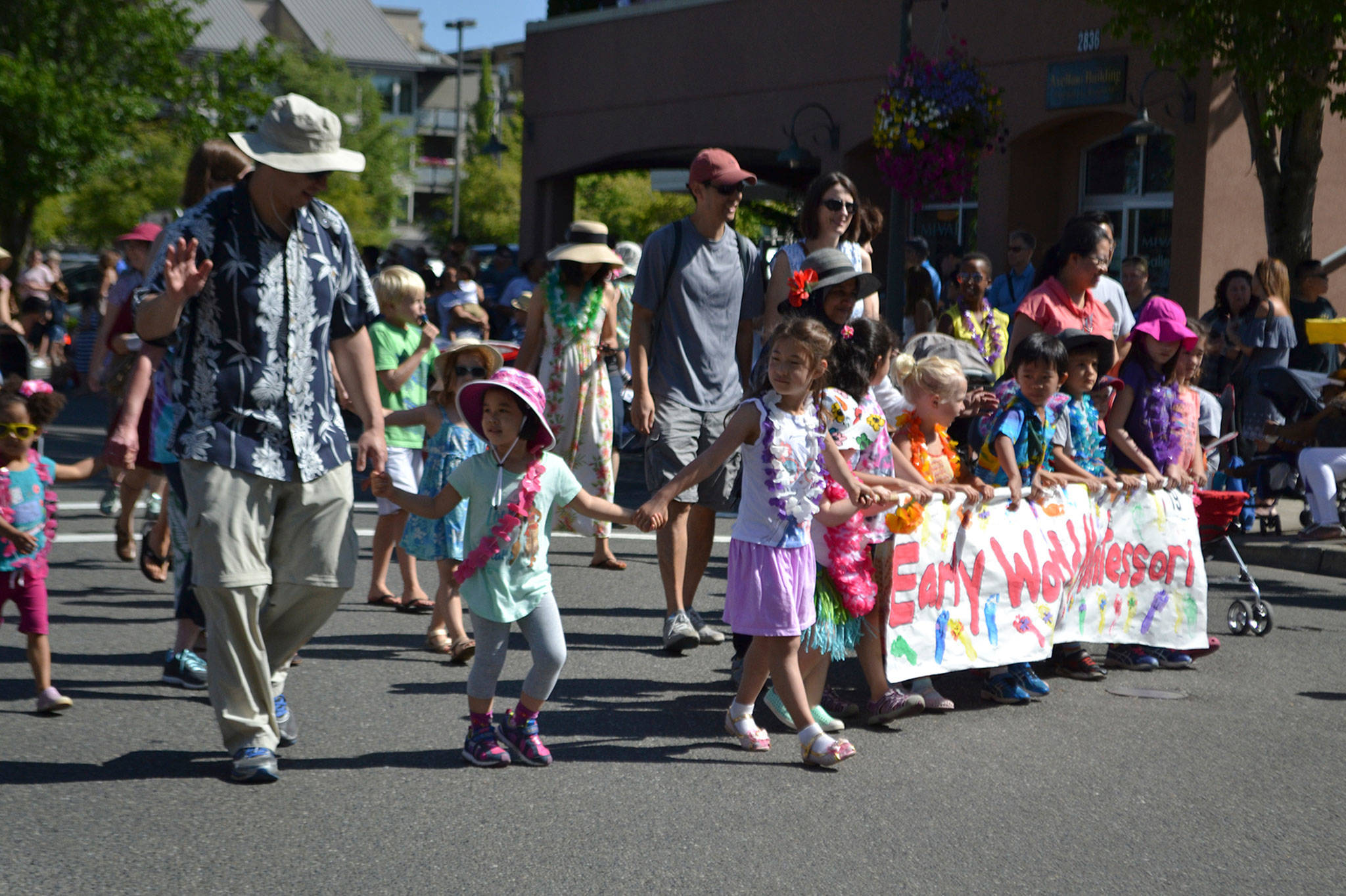 Early World Montessori students walked in the Summer Celebration parade in July 2018. The theme of this year’s event was “Island Vibes.” Katie Metzger/staff photo