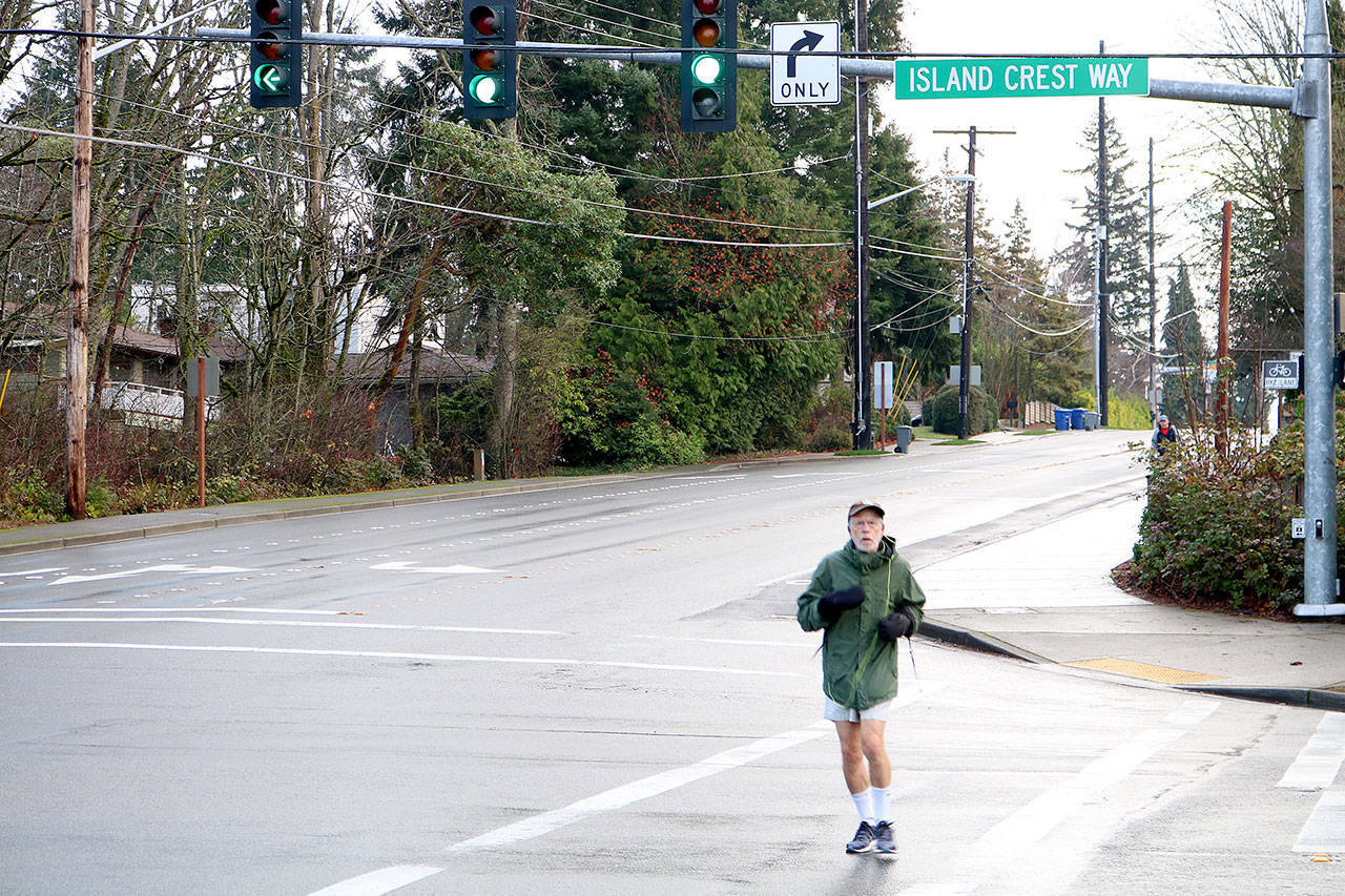 Mercer Island resident Steven Schickler jogs down a crosswalk between SE 40th ST and Island Crest Way Thursday Morning. Drew Stuart/staff photo.