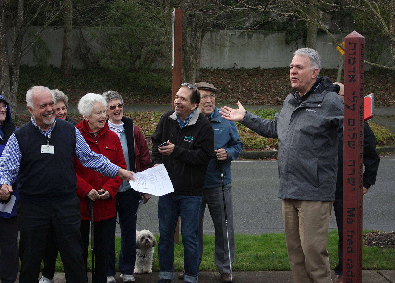 Greg Asimakoupoulos and Bob Howell from Covenant Shores lead a ceremony to dedicate Mercer Island’s newest peace pole on Jan. 18. Katie Metzger/staff photo