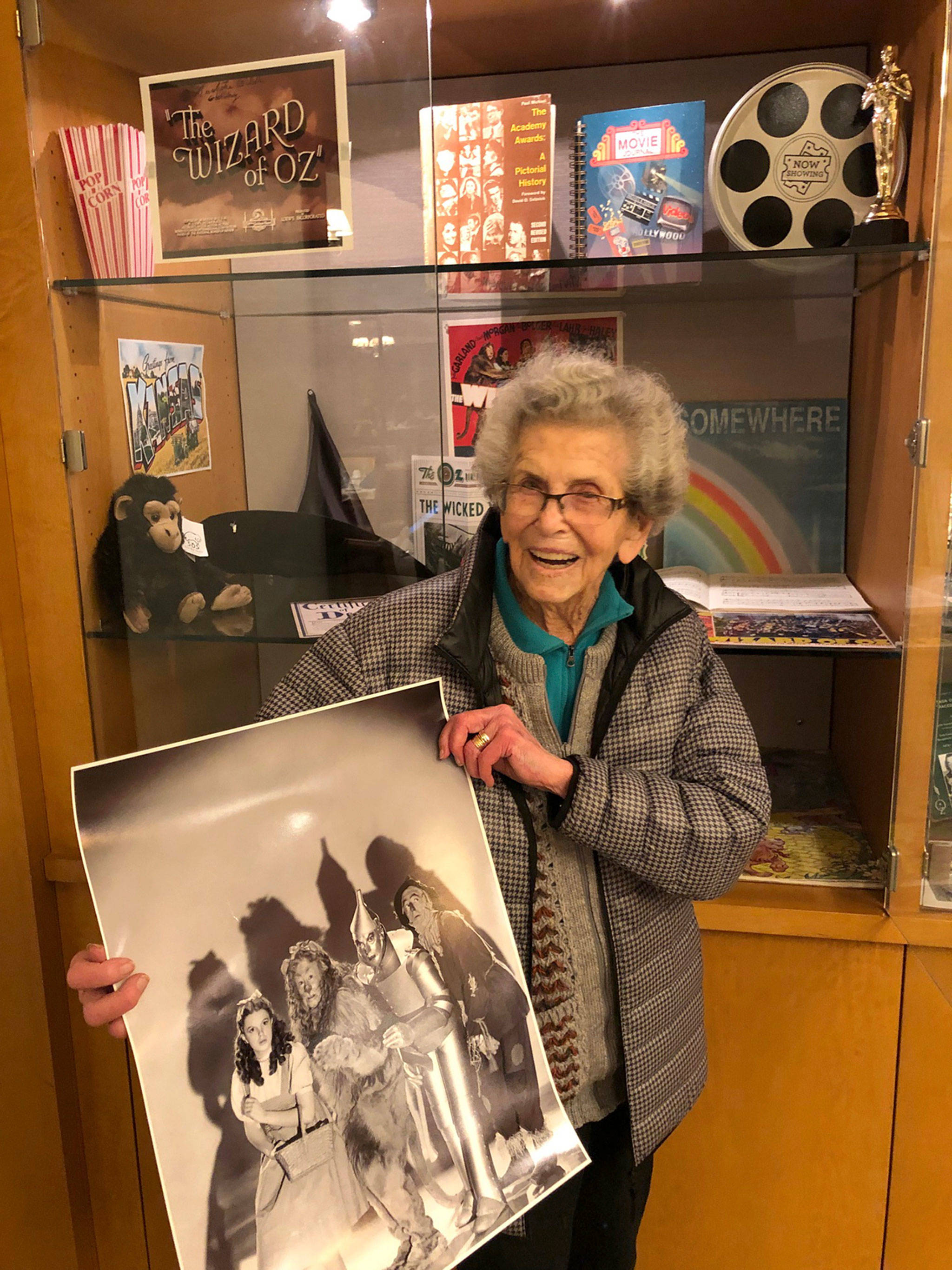 Mercer Island resident Meredythe Glass poses with memorabilia from “The Wizard of Oz” at Covenant Shores. Photo courtesy of Greg Asimakoupoulos