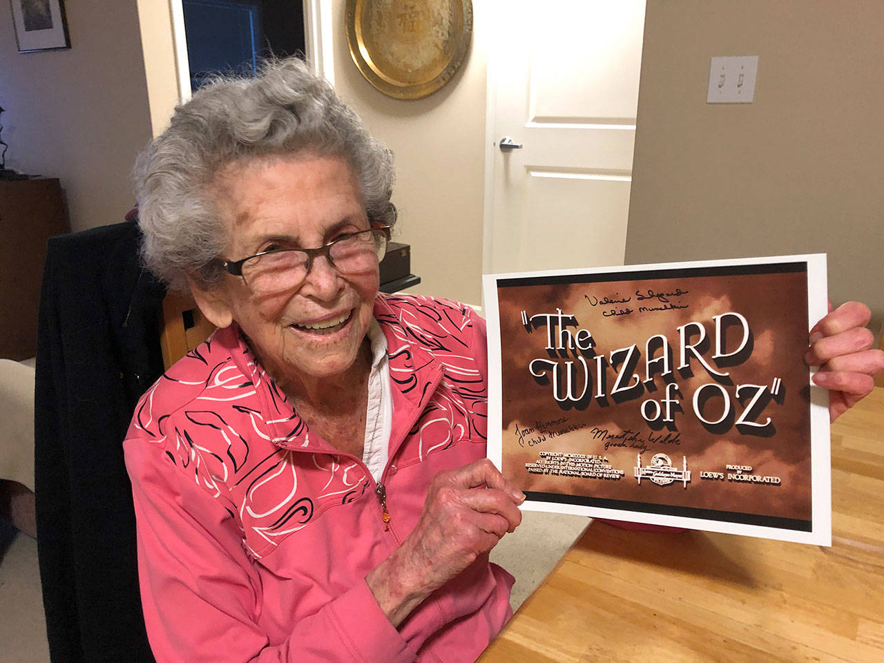 Mercer Island resident Meredythe Glass poses with memorabilia from “The Wizard of Oz.” Glass was an extra in the film, and will be the guest of honor at a party at her retirement community celebrating Hollywood on Feb. 22. Photo courtesy of Greg Asimakoupoulos