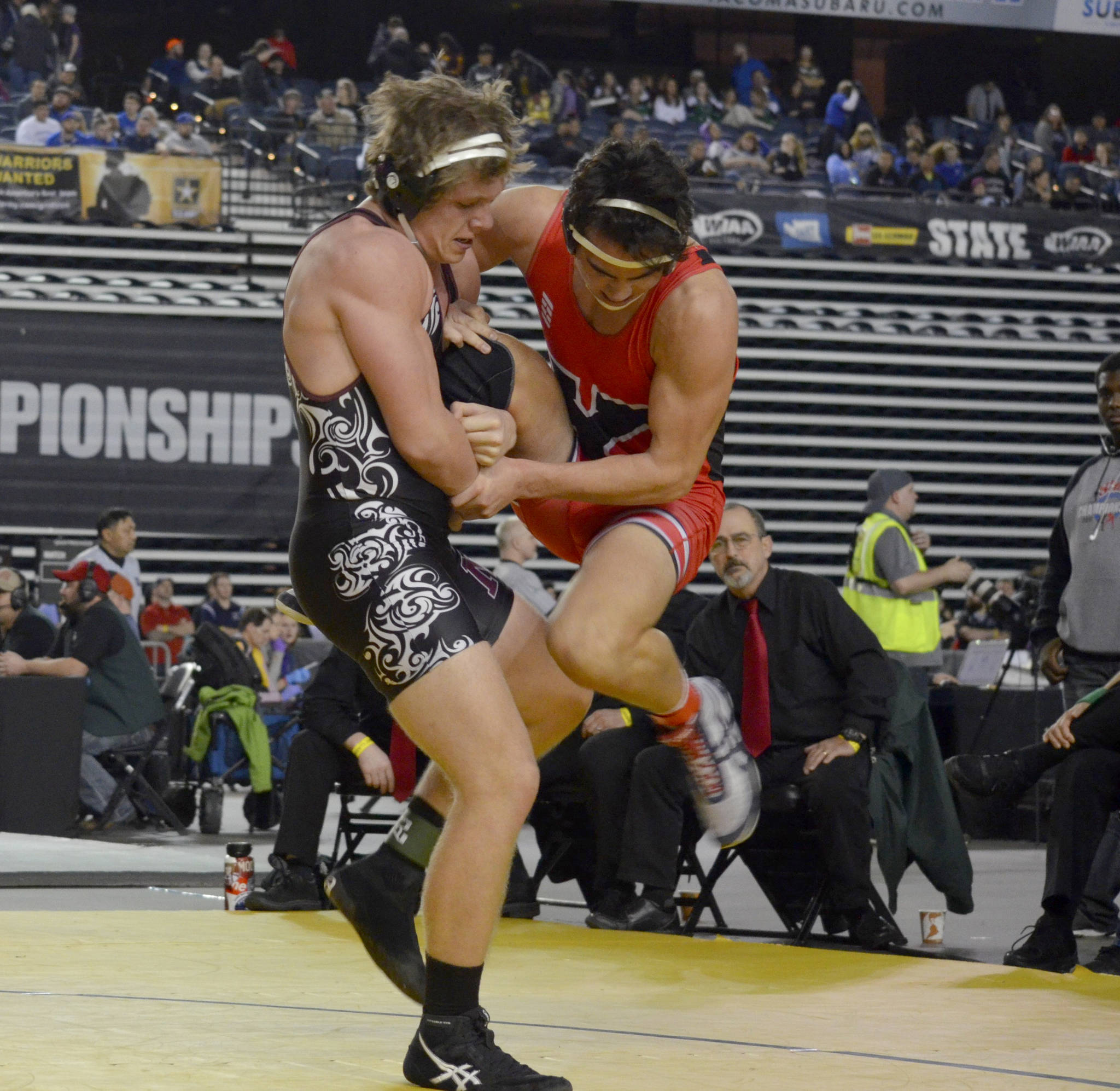 Mercer Island Islanders senior wrestler Donnie Howard, left, battles against Yelm’s Derrick Platt, right in the Mat Classic Class 3A 195-pound championship match. Platt earned a 3-2 victory against Howard on Feb. 16 at the Tacoma Dome. Photo courtesy of Billy Pruchno