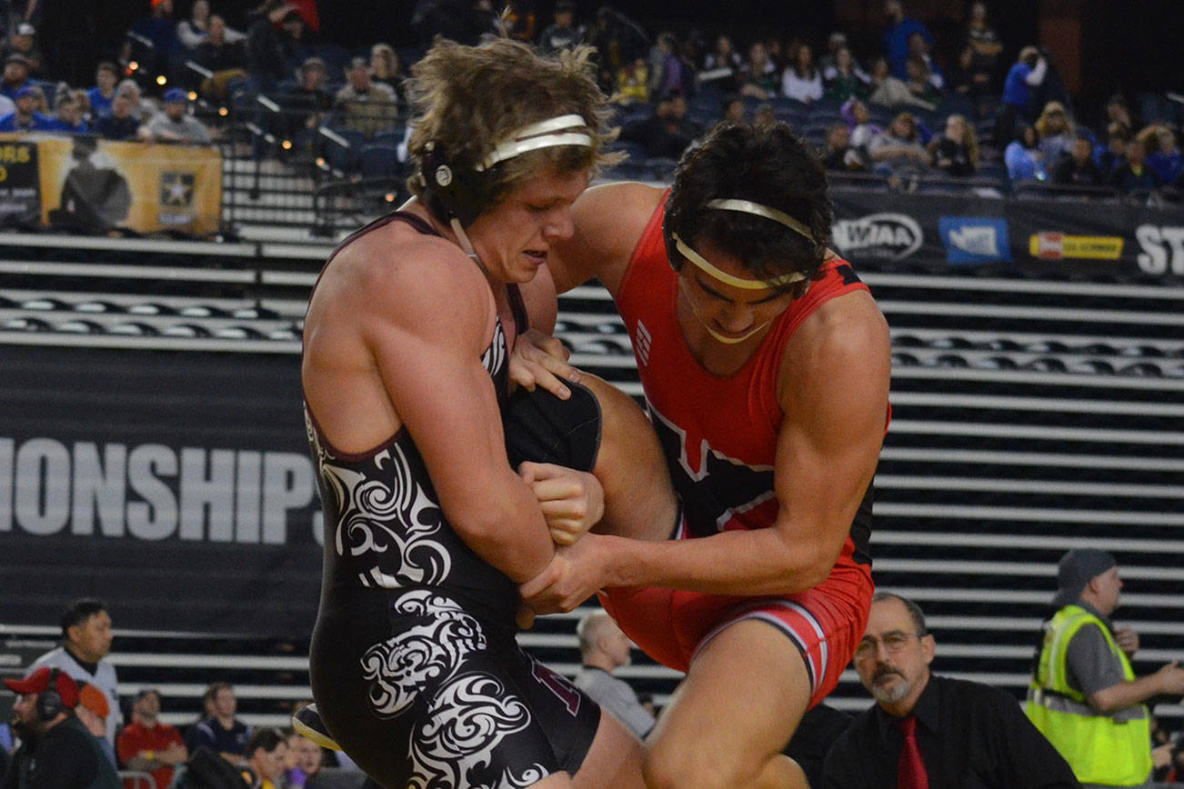 Mercer Island Islanders senior wrestler Donnie Howard, left, battles against Yelm’s Derrick Platt, right in the Mat Classic Class 3A 195-pound championship match. Platt earned a 3-2 victory against Howard on Feb. 16 at the Tacoma Dome. Photo courtesy of Billy Pruchno