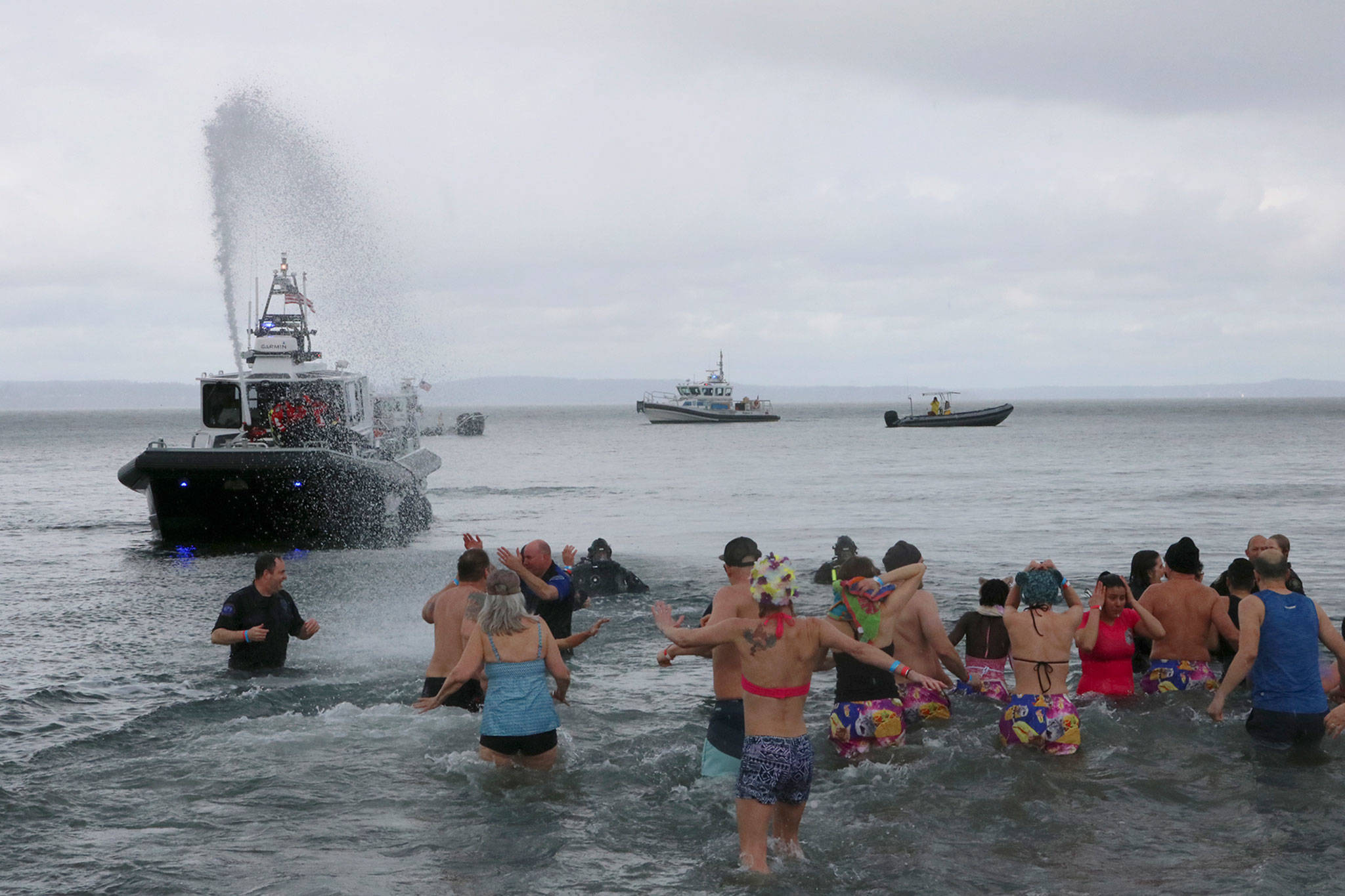 A King County Sheriff’s Office boat sprays water at polar plunge participants. Katie Metzger/staff photo