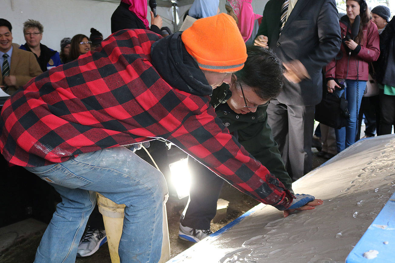 Redmond Mayor John Marchione was among many community members to place their hand prints in the wet cement below the new sign at the Muslim Association of Puget Sound in Redmond after the mosque’s old sign was vandalized in 2016. File photoMAPS Sign