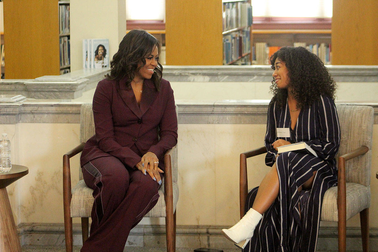 Former First Lady of the United States Michelle Obama, left, chats with Lestraundra Alfred, founder of Balanced Black Girl podcast at a private book club event at the Tacoma Public Library on Sunday, March 24. Olivia Sullivan/staff photo