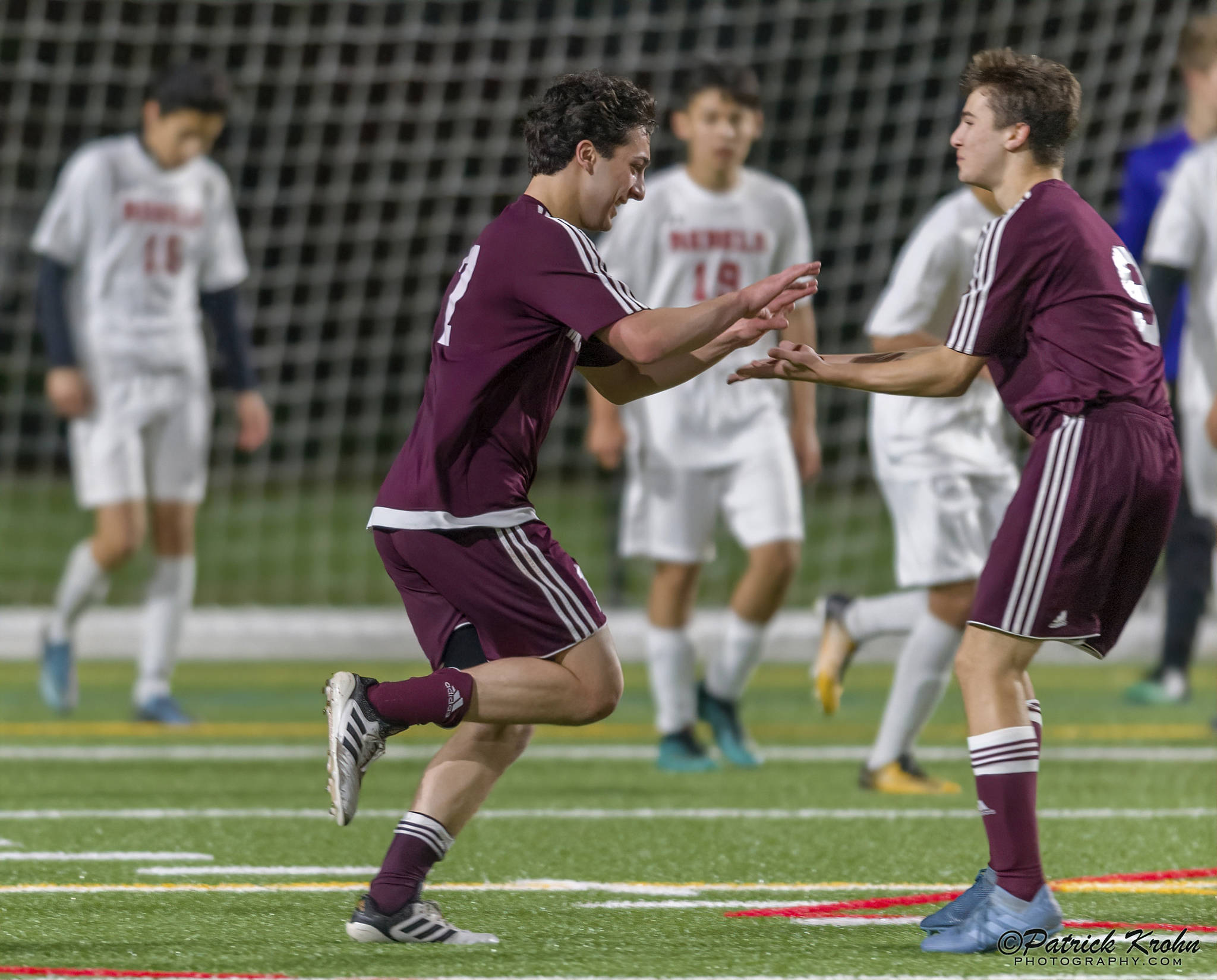 Mercer Island junior midfielder Luca Mtskhetadze, left, celebrates with teammate Jonah Hyman, right, after scoring on a header in the 87th minute of play, giving his team a 2-1 lead in overtime. Mercer Island held on for a 2-1 victory against the Juanita Rebels on April 11. Photo courtesy of Patrick Krohn/Patrick Krohn Photography