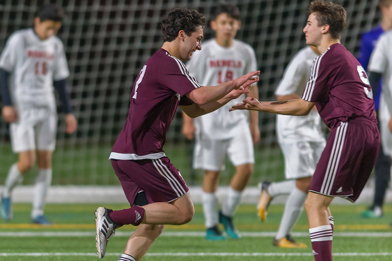 Mercer Island junior midfielder Luca Mtskhetadze, left, celebrates with teammate Jonah Hyman, right, after scoring on a header in the 87th minute of play, giving his team a 2-1 lead in overtime. Mercer Island held on for a 2-1 victory against the Juanita Rebels on April 11. Photo courtesy of Patrick Krohn/Patrick Krohn Photography