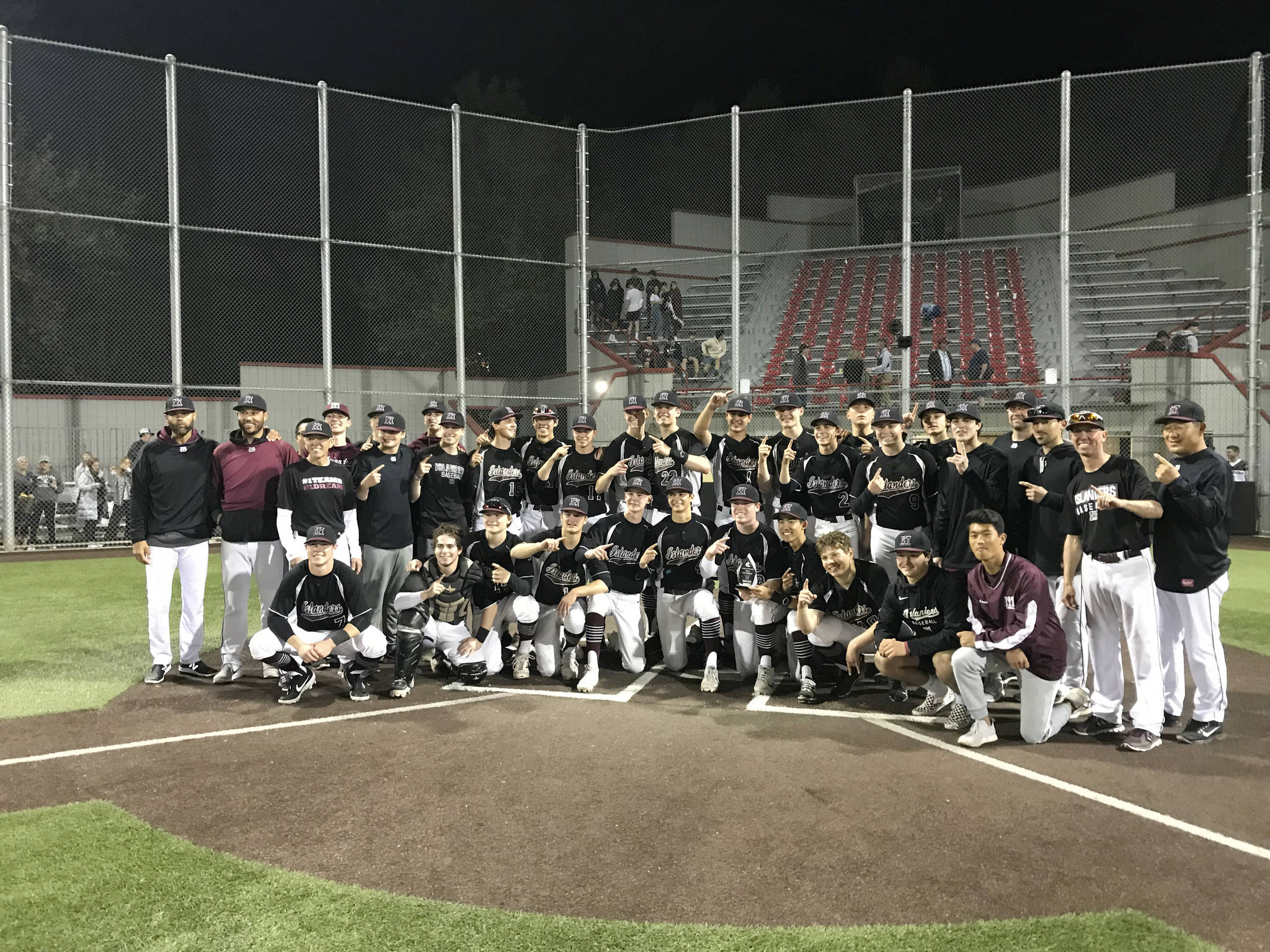 The Mercer Island Islanders pose for a team photo after clinching a berth at the Class 3A state tournament courtesy of a 10-3 victory against the Interlake Saints in the 3A KingCo championship game on May 6 at Bannerwood Park in Bellevue. Shaun Scott/staff photo