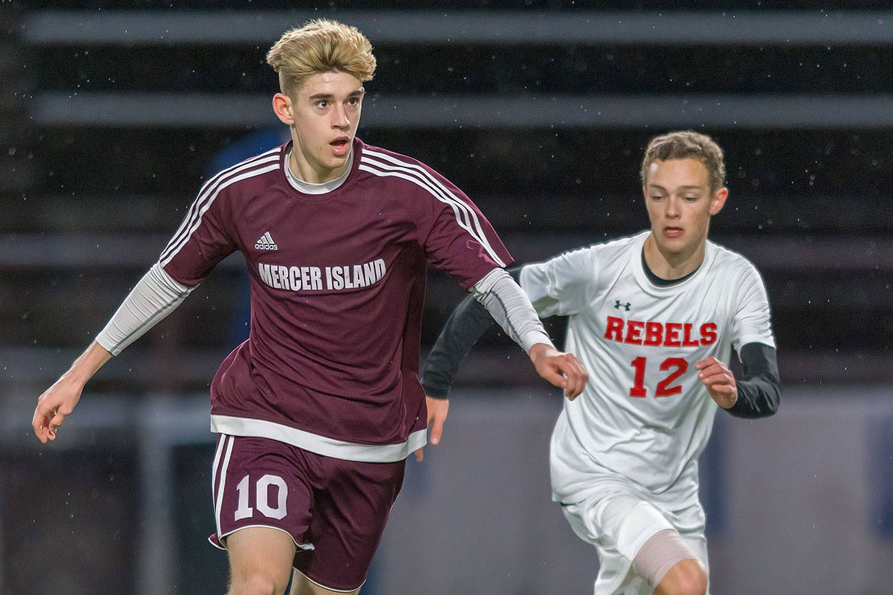 Mercer Island senior Matthew Capone, left, dribbles the ball up field while being guarded by Juanita sophomore Andrew Taylor in a game on April 11. Juanita defeated Mercer Island, 2-1, in a loser-out, 3A KingCo playoff game on May 7 at Mercer Island High School. Photo courtesy of Patrick Krohn/Patrick Krohn Photography
