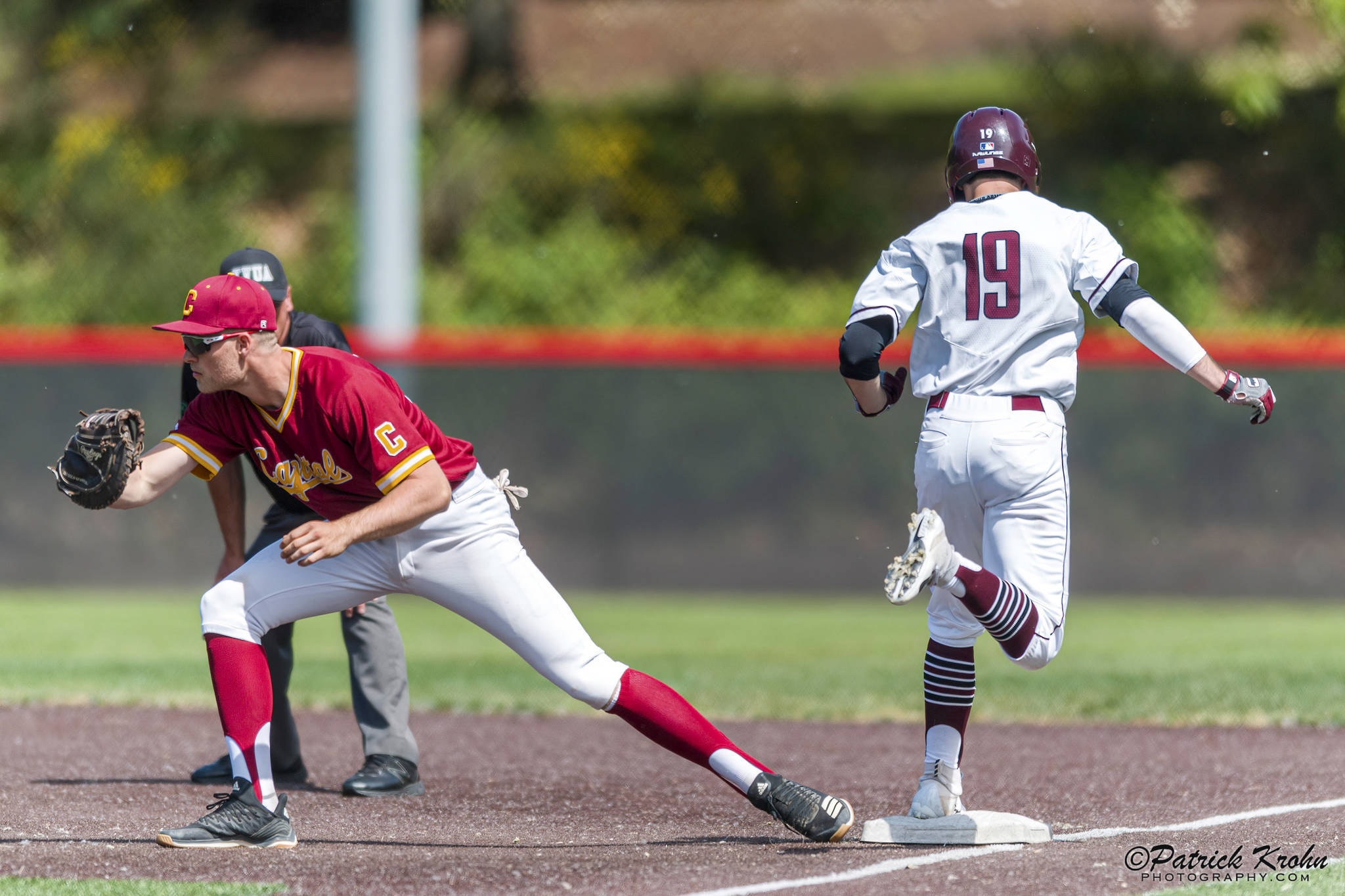 Mercer Island Islanders senior Grant Stading (No. 19) hustles down the first-base line after hitting a grounder against the Capital Cougars. Capital defeated Mercer Island, 7-1, in the first round of the 3A state playoffs. Photo courtesy of Patrick Krohn/Patrick Krohn Photography