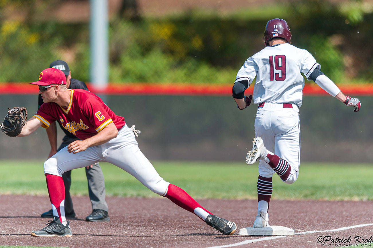 Mercer Island Islanders senior Grant Stading (No. 19) hustles down the first-base line after hitting a grounder against the Capital Cougars. Capital defeated Mercer Island, 7-1, in the first round of the 3A state playoffs. Photo courtesy of Patrick Krohn/Patrick Krohn Photography