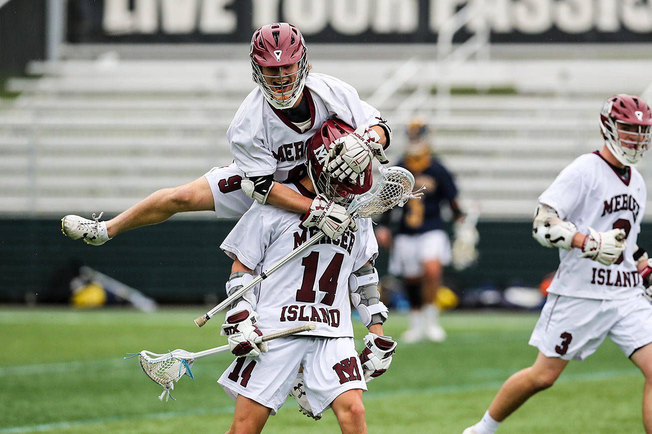 Mercer Island player Glen Mahony (No. 9) leaps on the back of Will Wheeler (No. 14) during the 3A state championship game against the Bellevue Wolverines. Mercer Island defeated Bellevue 14-6 on May 25 at the Starfire Sports Complex in Tukwila. Photo courtesy of Rick Edelman/Rick Edelman Photography