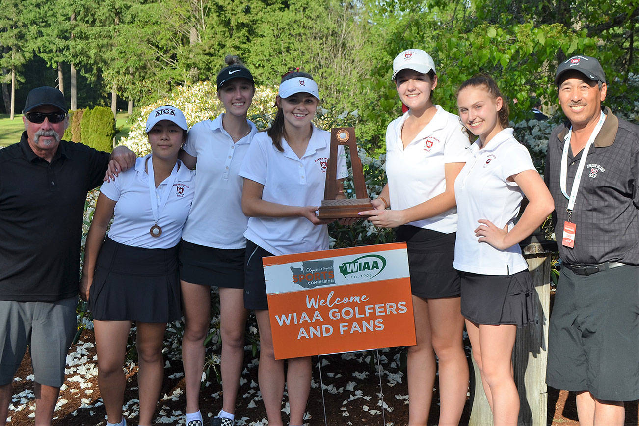 Coach Don Papasedero, Gihoe Seo, Grace Shaddle, Annelise Rorem, Katelyn Travis, Lilly Pruchno and coach Tim Okamura take a team photo with the 3A third place trophy on May 22 at Hawks Prairie Golf Course in Lacey. Photo courtesy of Billy Pruchno
