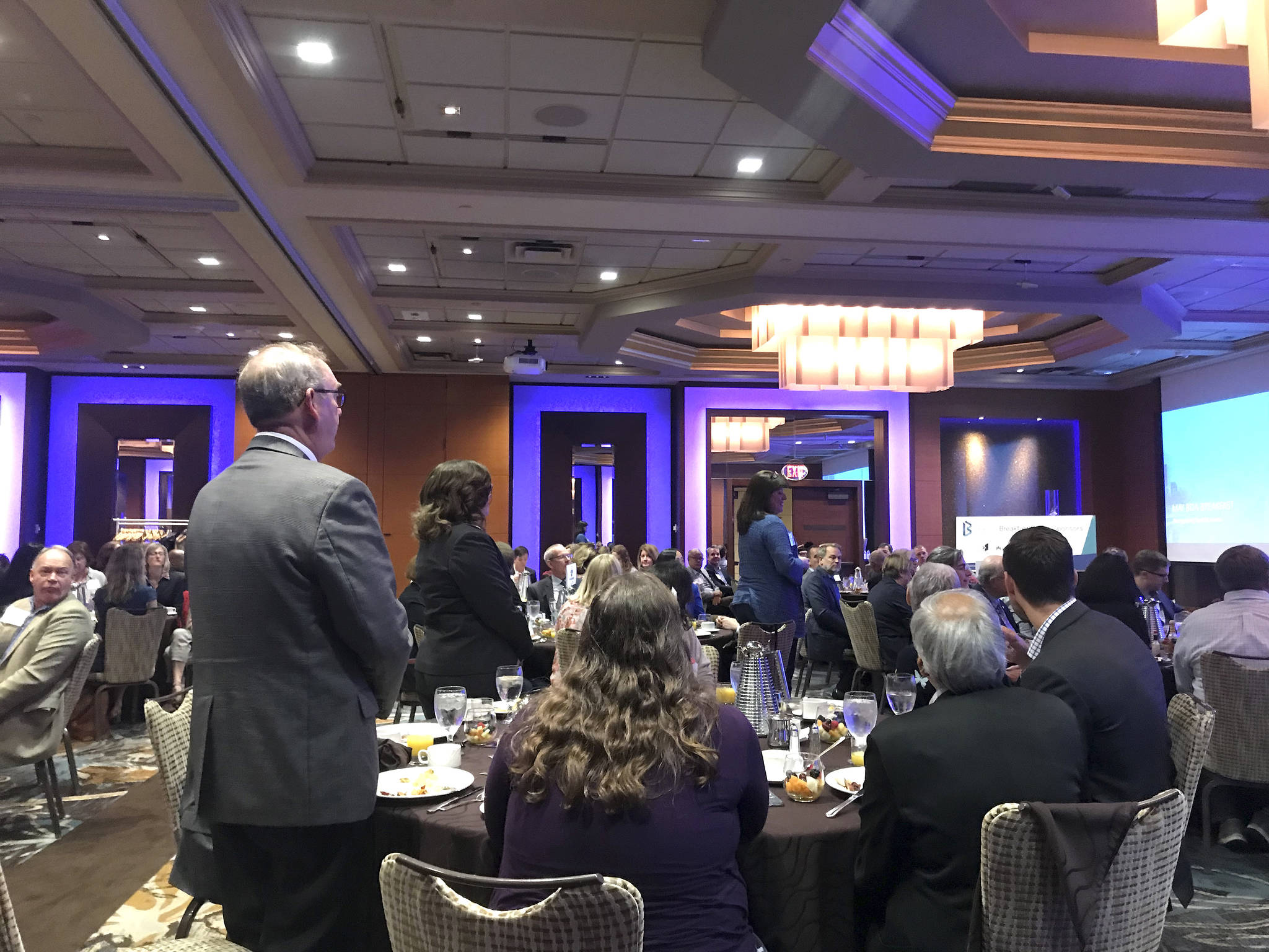 Bellevue Mayor John Chelminiak stands as former Washongton Gov. Christine Gregoire, who now serves as CEO of Challenge Seattle, thanked local officials for their effort to work with Microsoft in curbing the affordable housing crisis. Kailan Manandic / staff photo