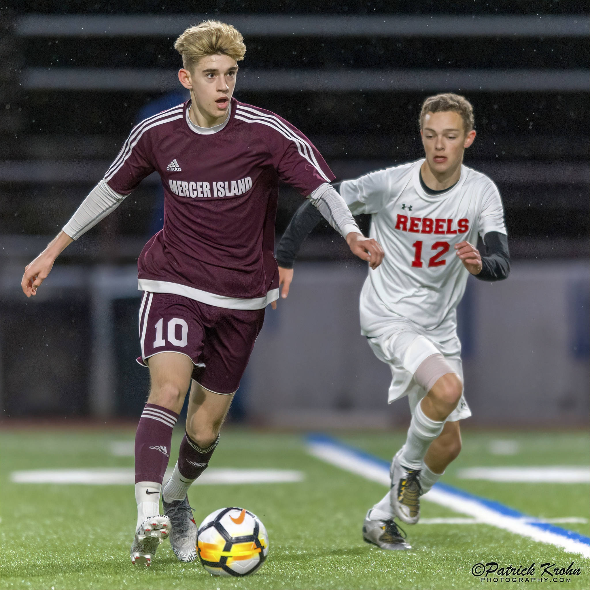 Mercer Island senior Matthew Capone, left, dribbles the ball up field while being guarded by Juanita sophomore Andrew Taylor in a game on April 11. Capone earned first-team all-3A KingCo honors as a midfielder during the 2019 season. Photo courtesy of Patrick Krohn/Patrick Krohn Photograph