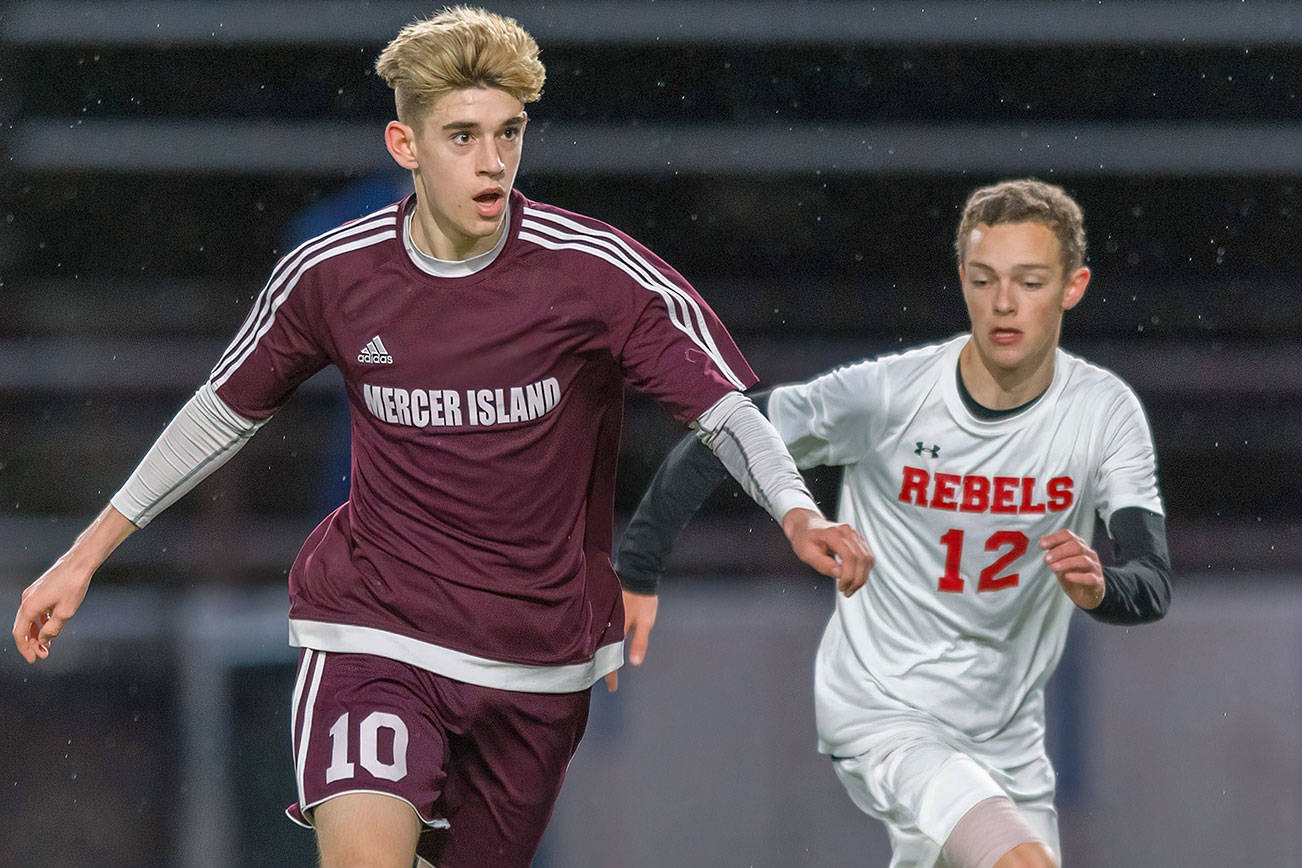 Mercer Island senior Matthew Capone, left, dribbles the ball up field while being guarded by Juanita sophomore Andrew Taylor in a game on April 11. Capone earned first-team all-3A KingCo honors as a midfielder during the 2019 season. Photo courtesy of Patrick Krohn/Patrick Krohn Photography