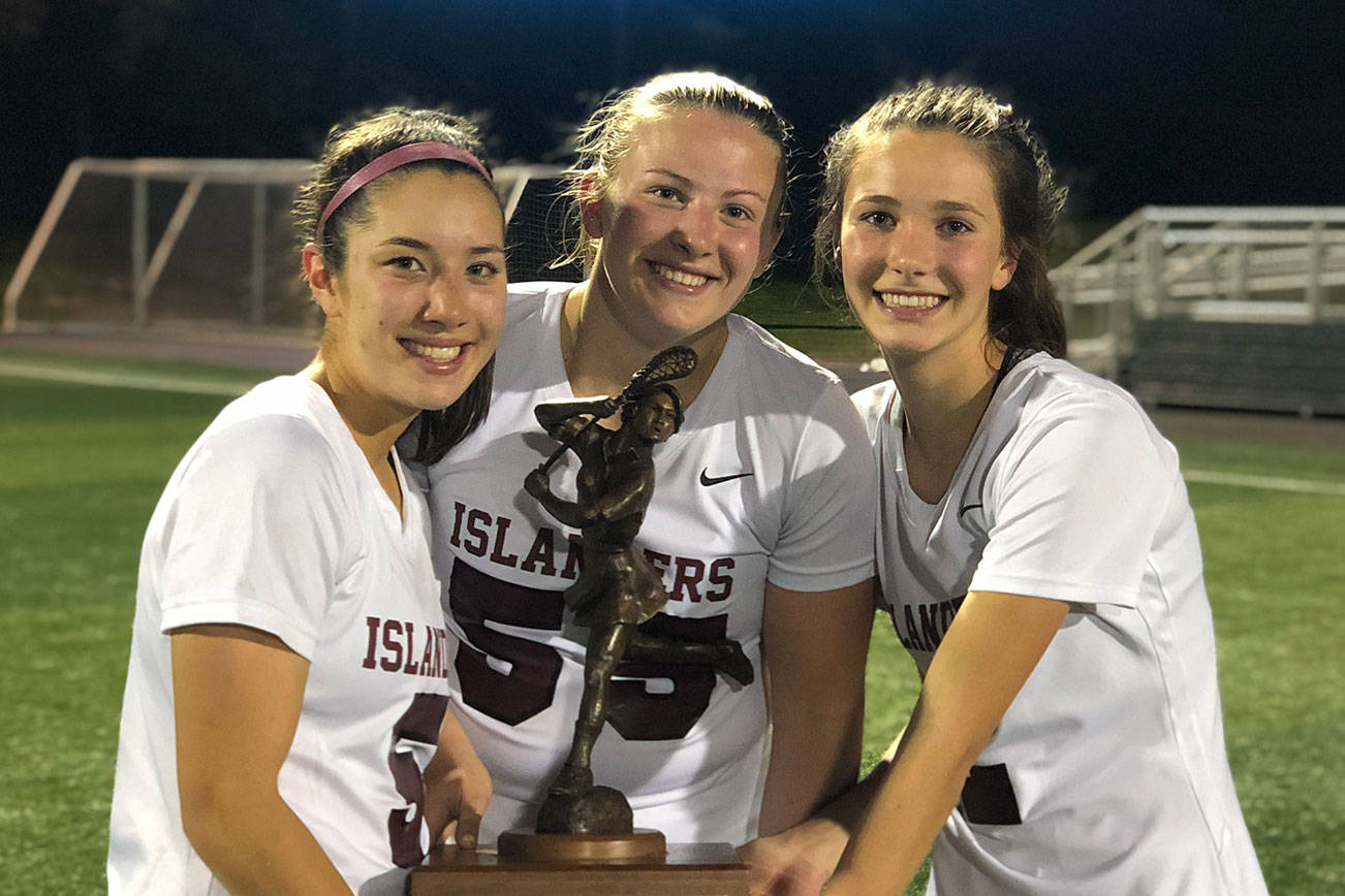Mercer Island girls lacrosse players Grace Fujinaga, Annabelle Gersch and Hannah Tiscornia hold the state championship trophy following their 10-9 victory against Bainbridge Island in the Washington Schoolgirls Lacrosse Association championship game on May 17. Photo courtesy of Kathy Gersch