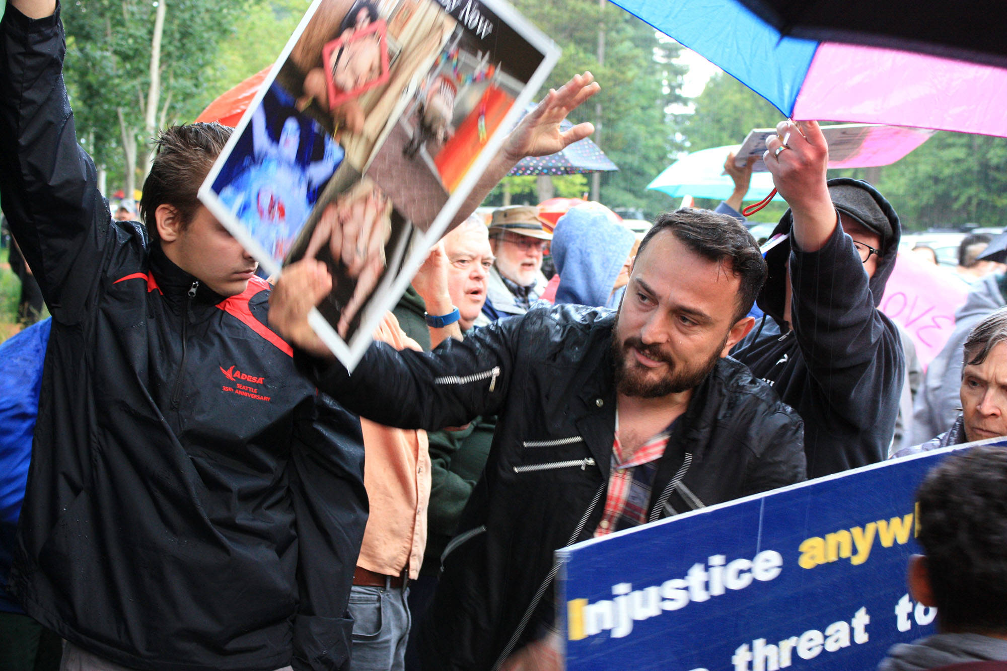 A protester of the Drag Queen Story Hour holds up erotica for families and children as they exit the event at Fairwood Library near Renton on June 27. Aaron Kunkler/Staff photo